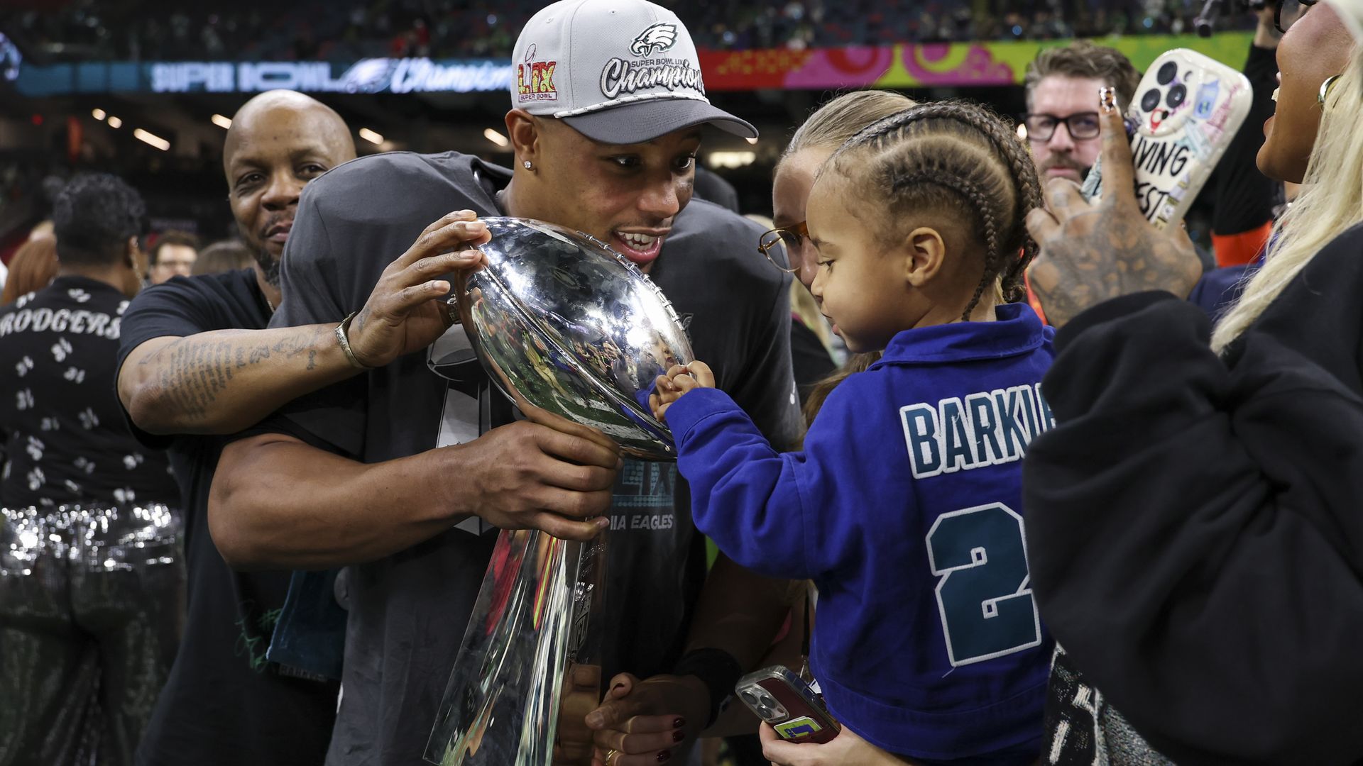 Eagles running back Saquon Barkley holds the Vince Lombardi Trophy.