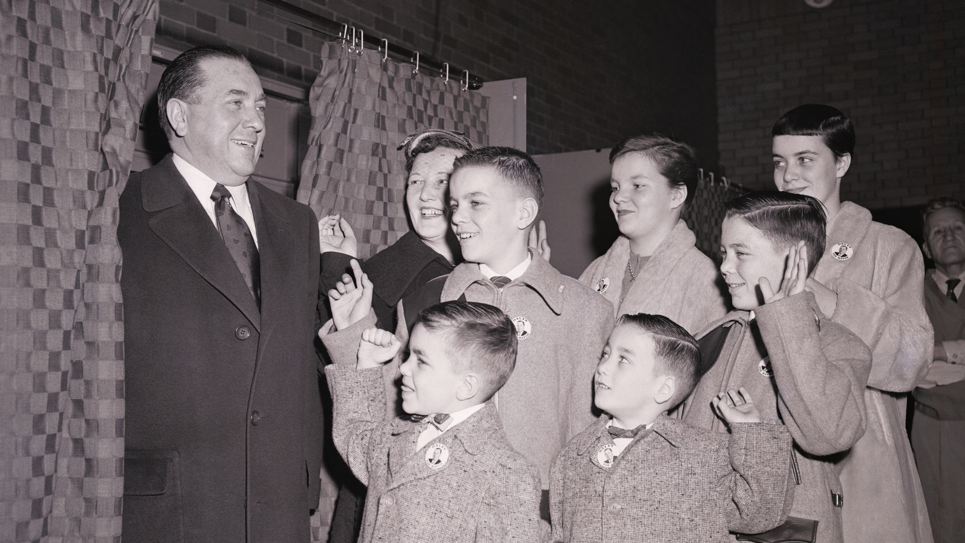 Photo of a man voting with his children