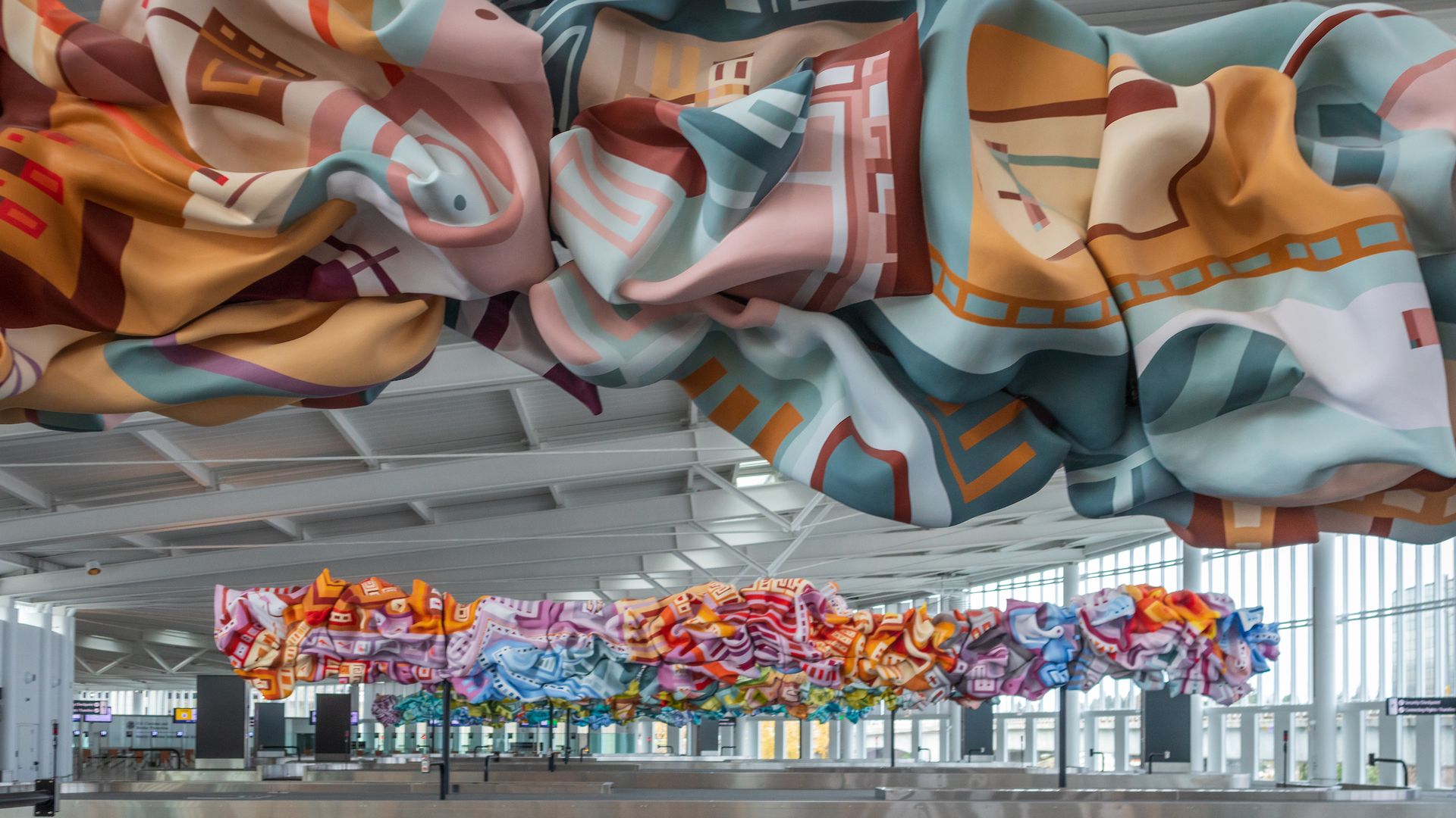 Large undulating colorful sculptures at an airport. 
