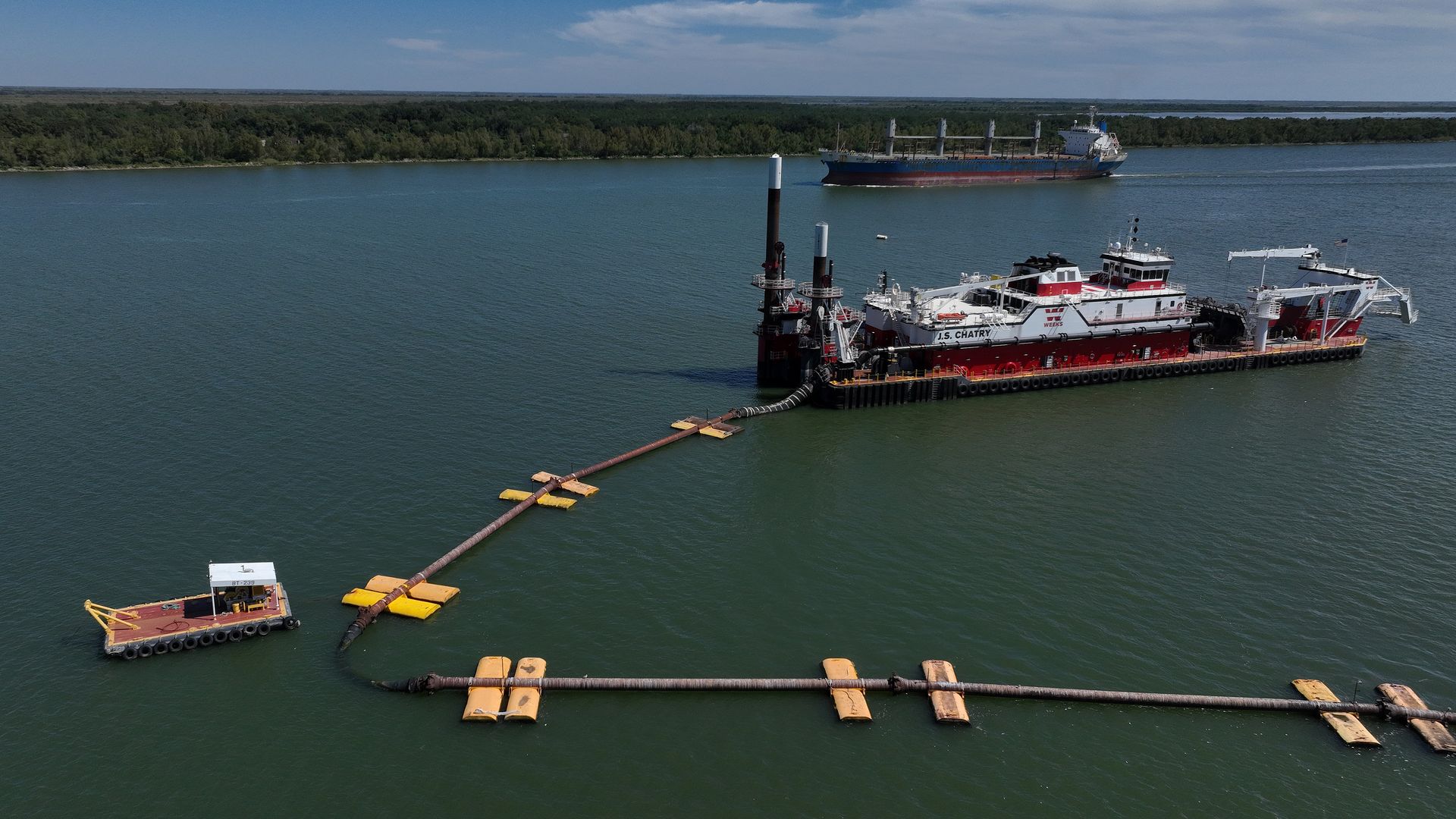 Photo shows ships on the Mississippi River building an underwater levee.