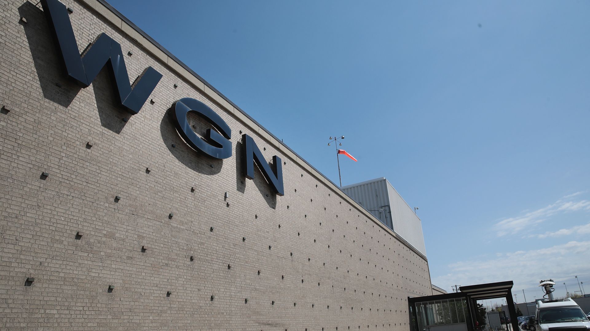Photo of a side of a building with the letters "WGN" on it. 
