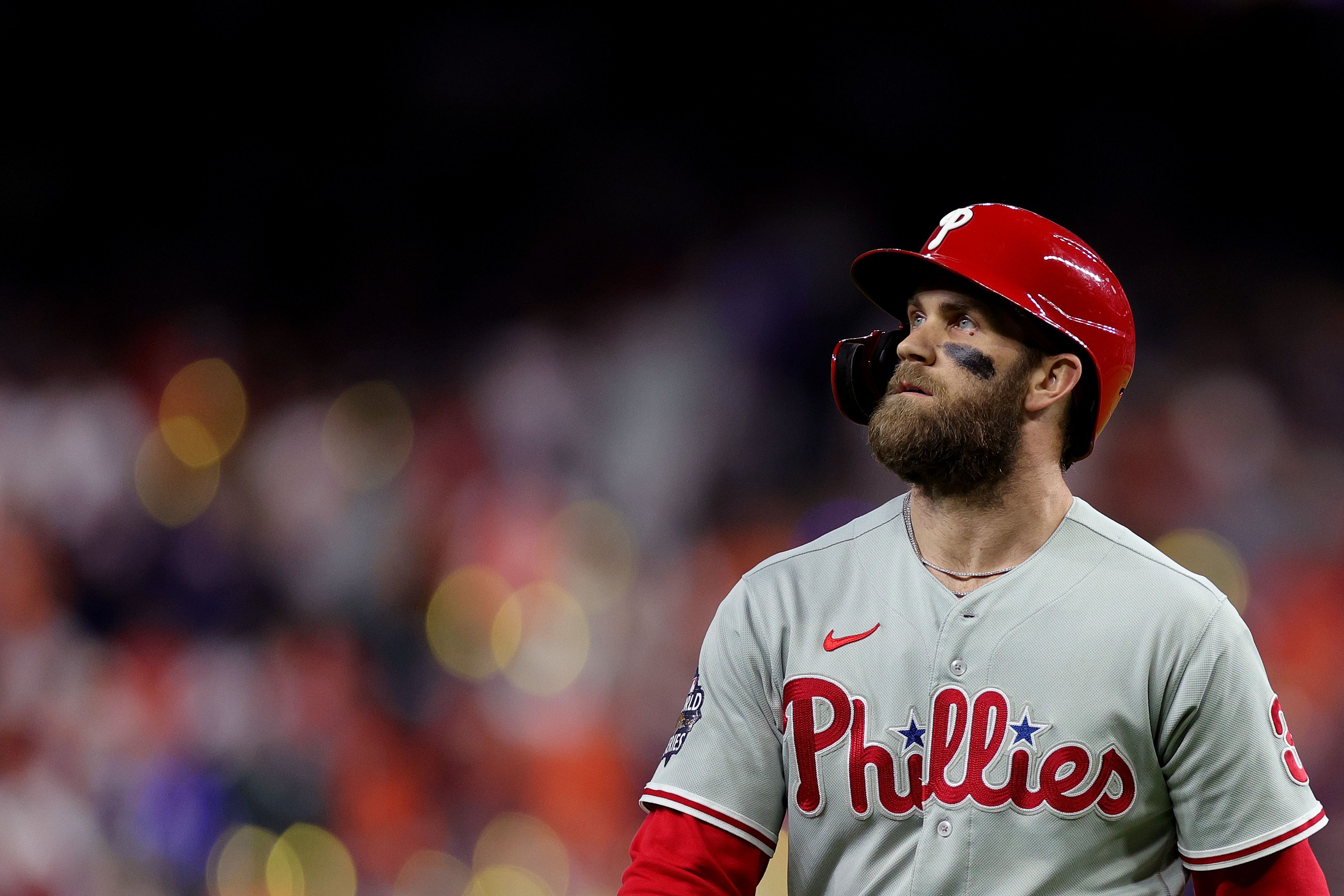 Bryce Harper stares off into the distance in front of a blurred-out crowd.
