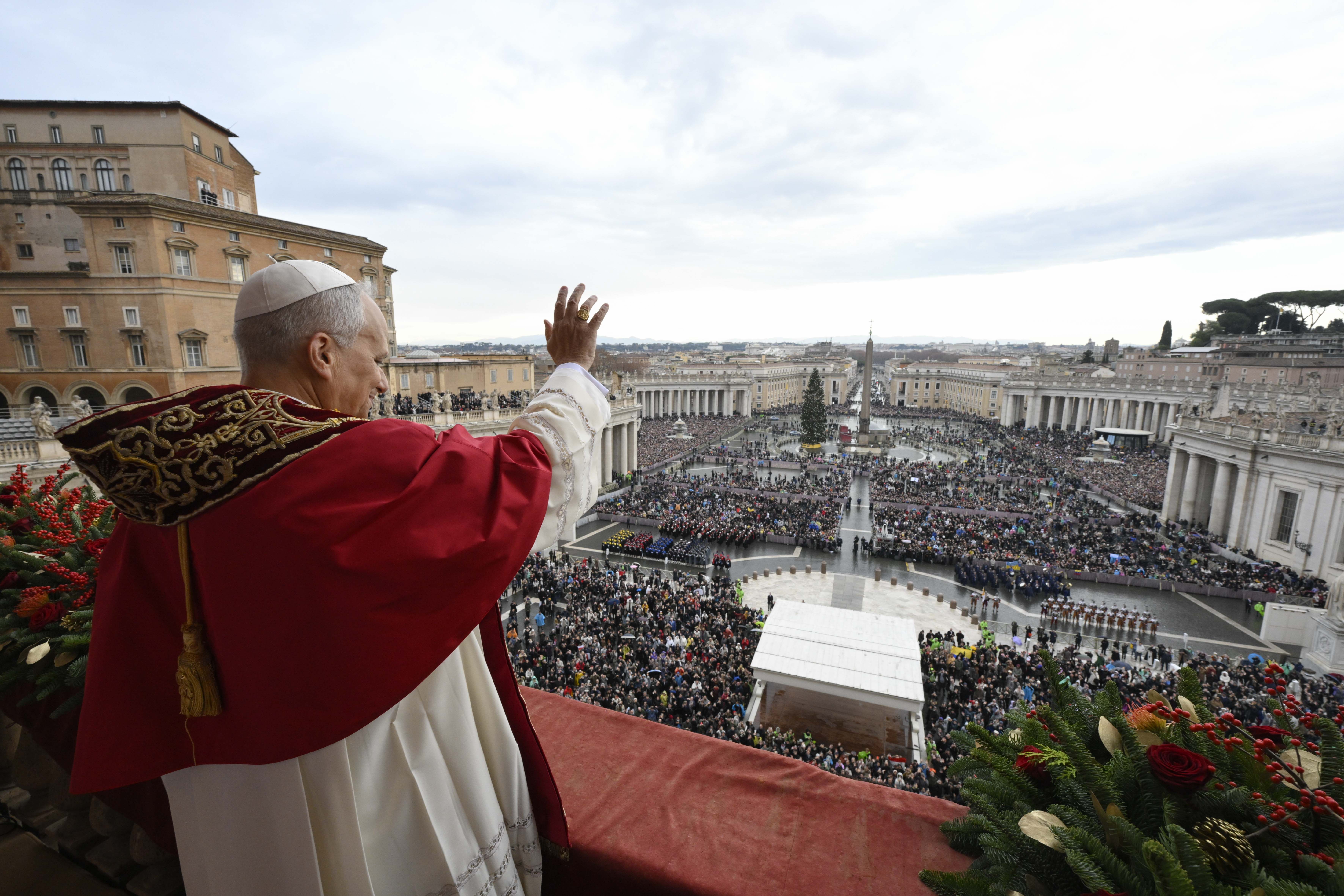Pope Leo XIV waves from the balcony of St. Peter's Basilica before speaking to worshippers gathered in Vatican City during his first Christmas as pontiff.
