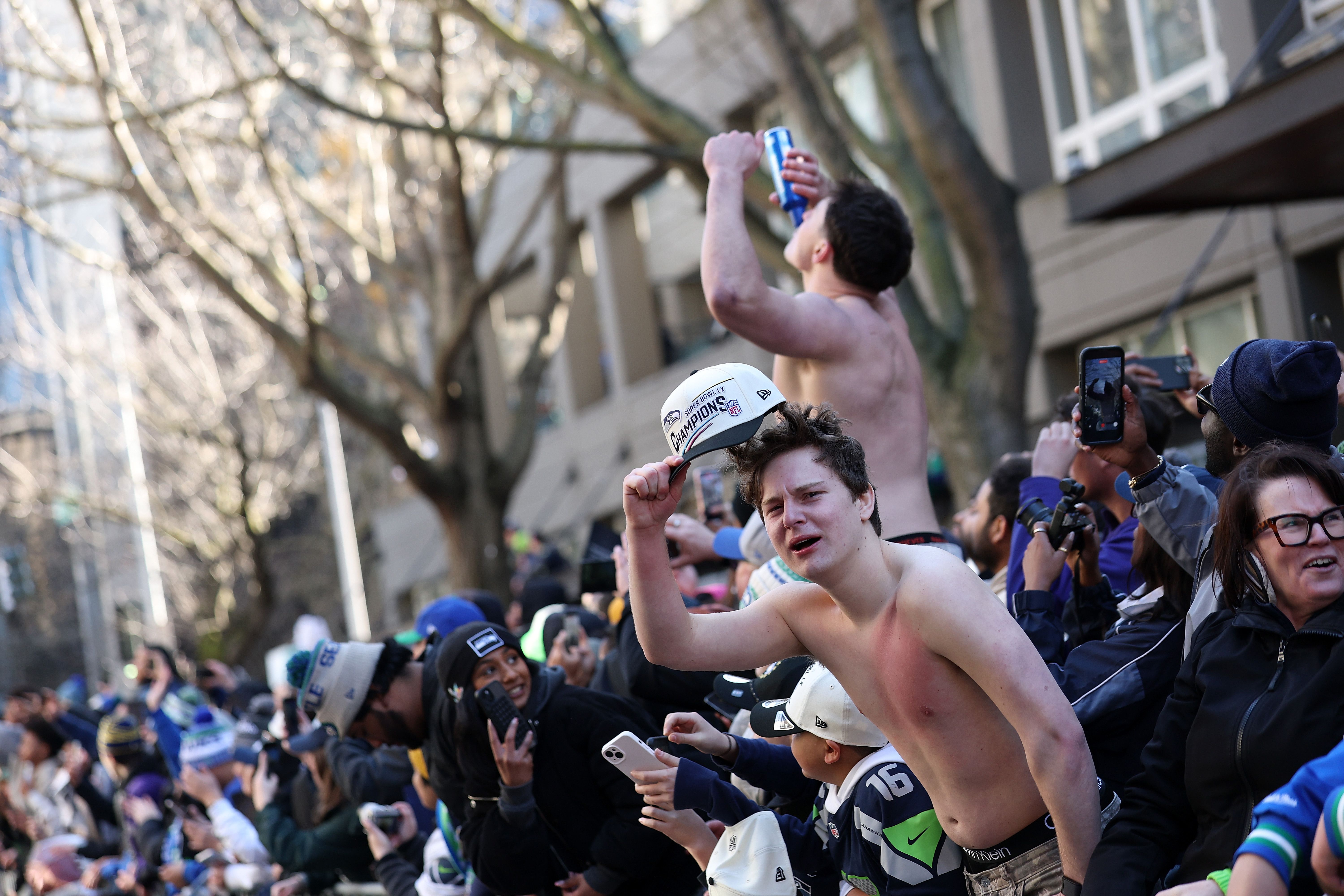 A shirtless man is among the hundreds of thousands of revelers at the parade.