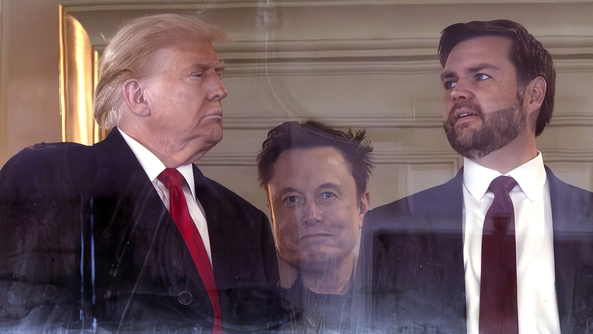 Donald TrumpElon Musk and JD Vance attend stand together.