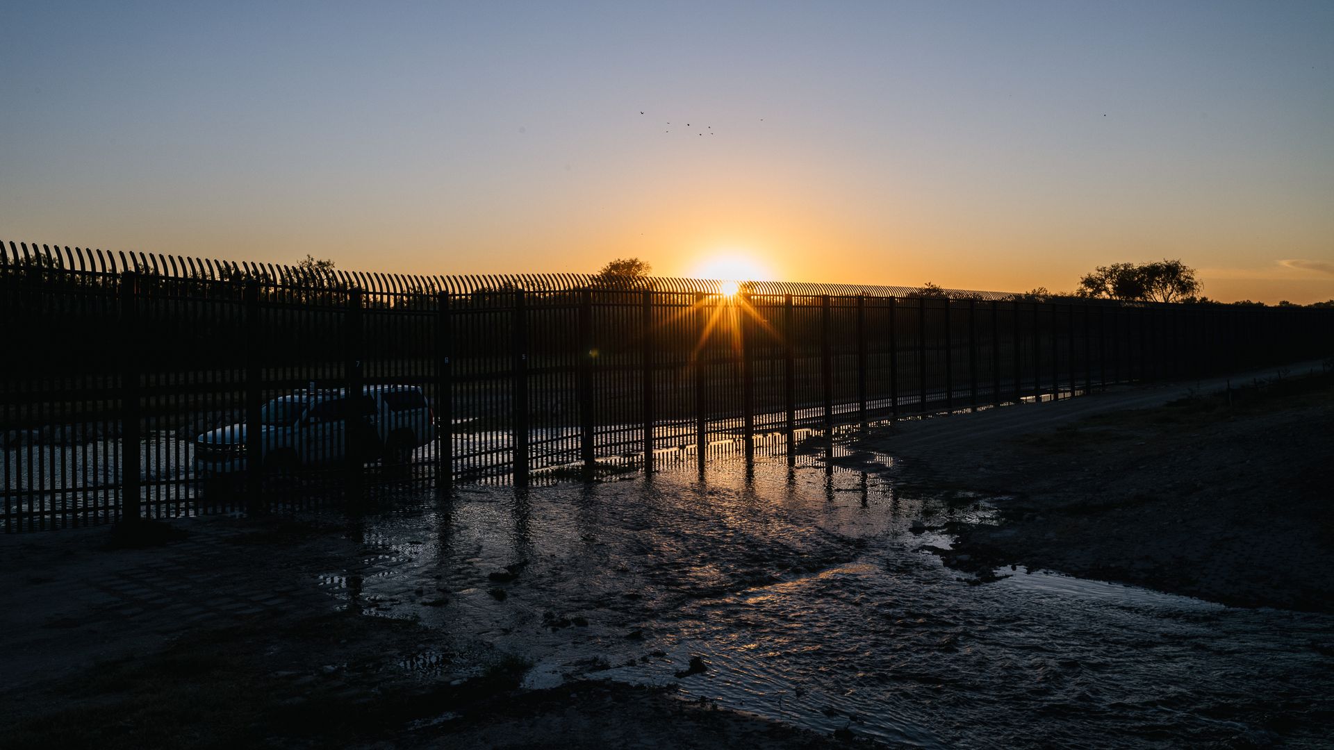  A Border Patrol vehicle is driven along a section of the southern border wall on September 23, 2021 in Del Rio, Texas.