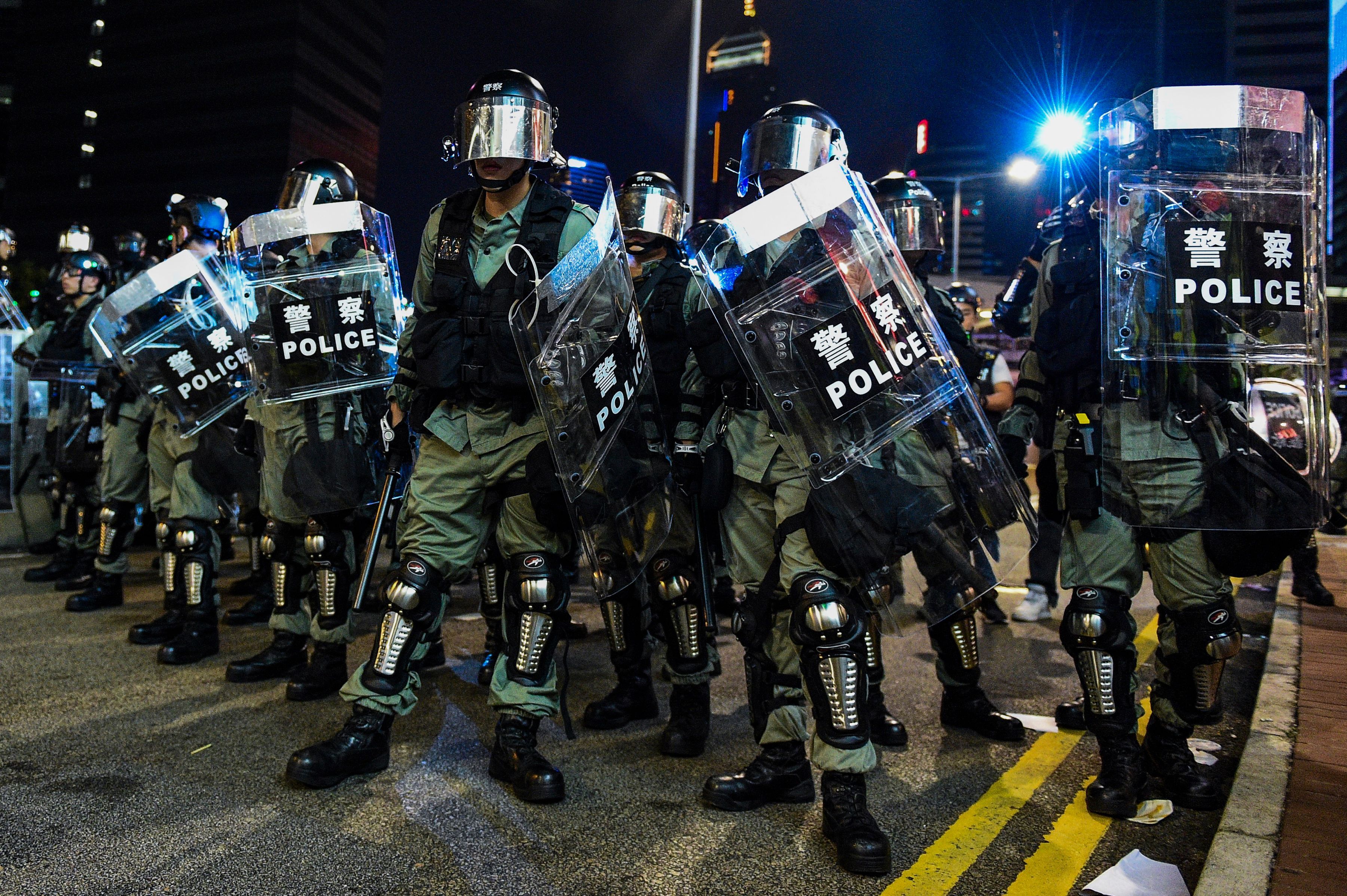 Riot police stand guard near the central government offices in the Admiralty area in Hong Kong