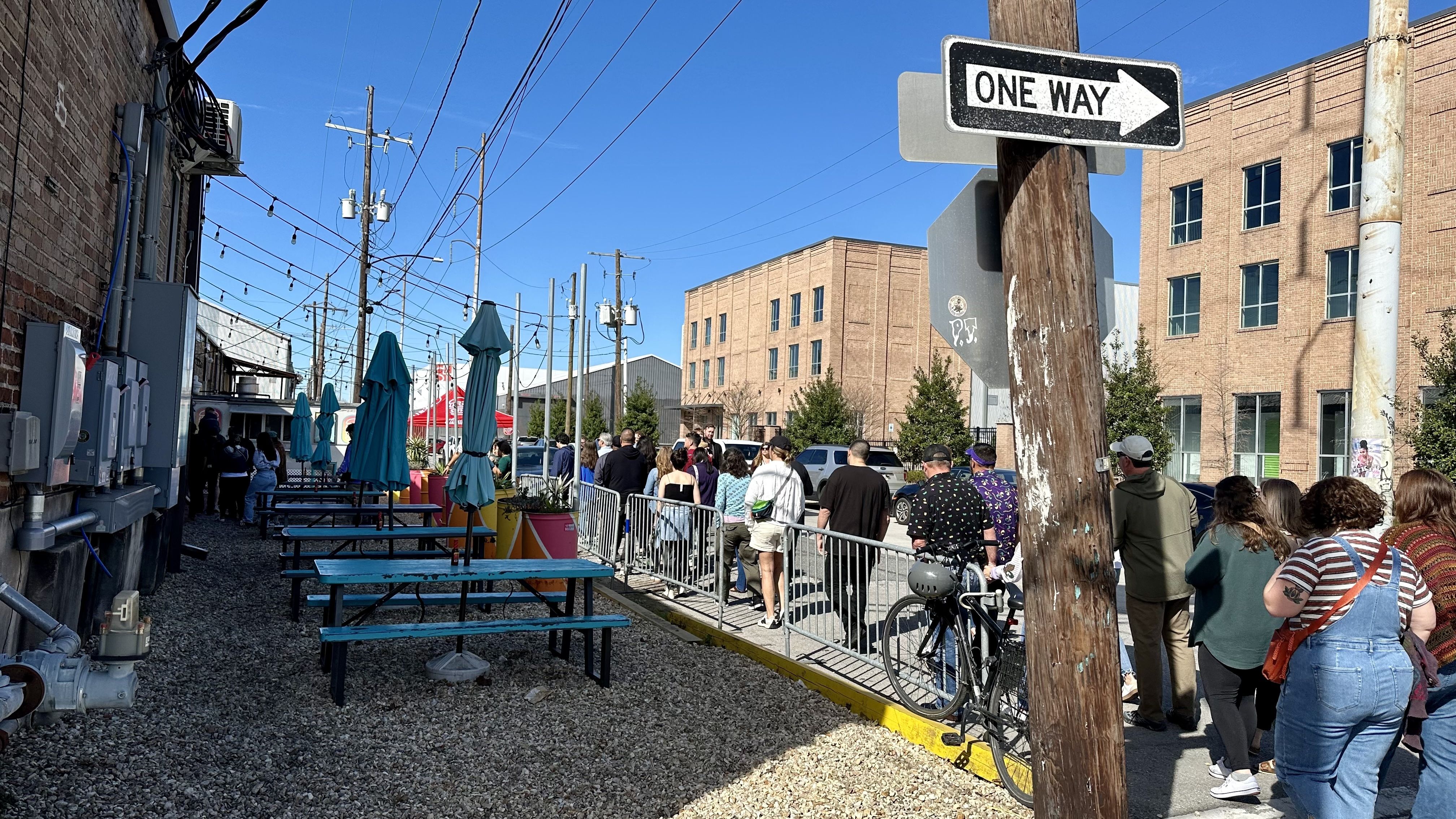 Photo shows a long line of people.