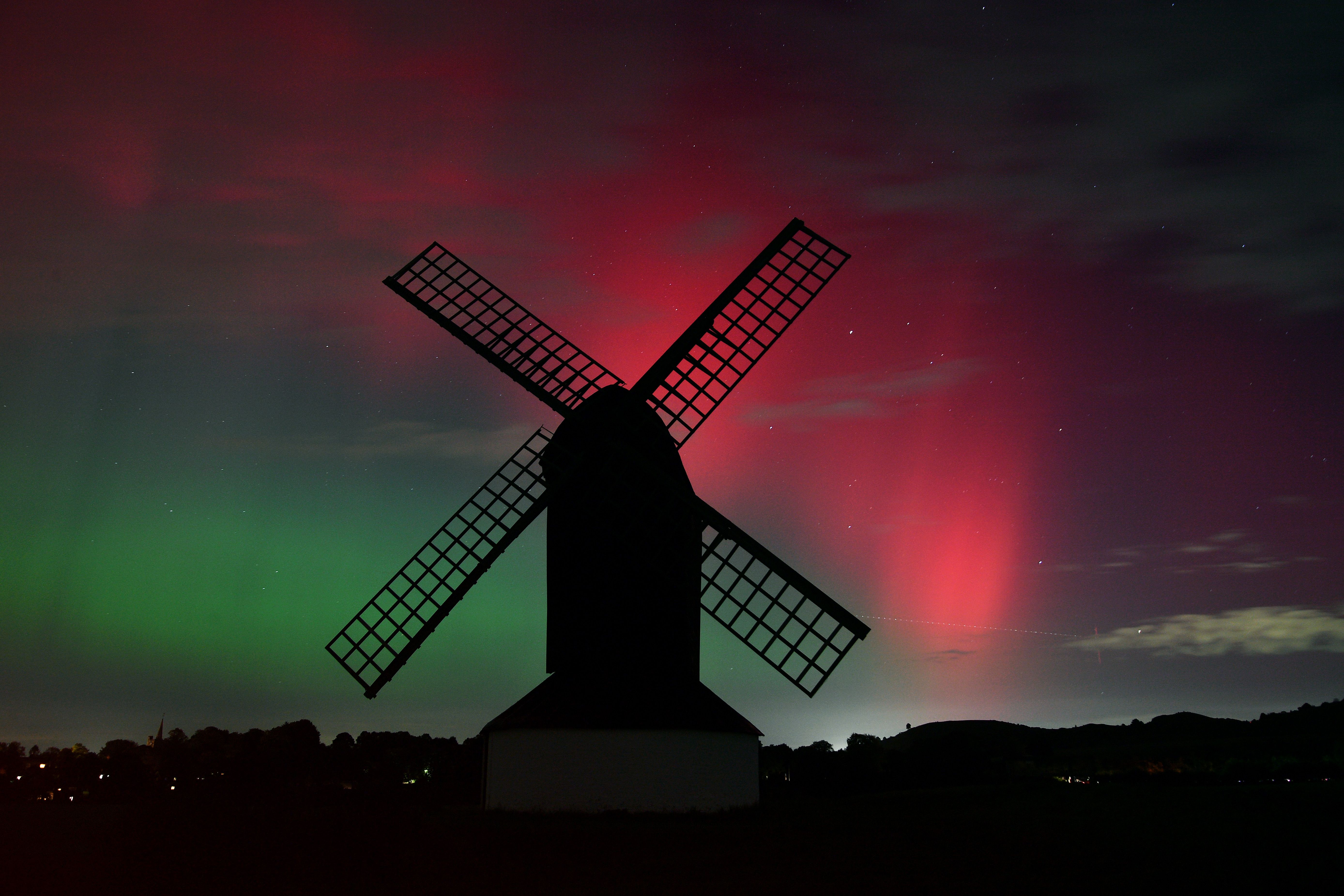 Red-green Aurora Borealis lights up the night sky over Pitstone Windmill in Buckinghamshire on October 10, 2024 in Pitstone, United Kingdom. 