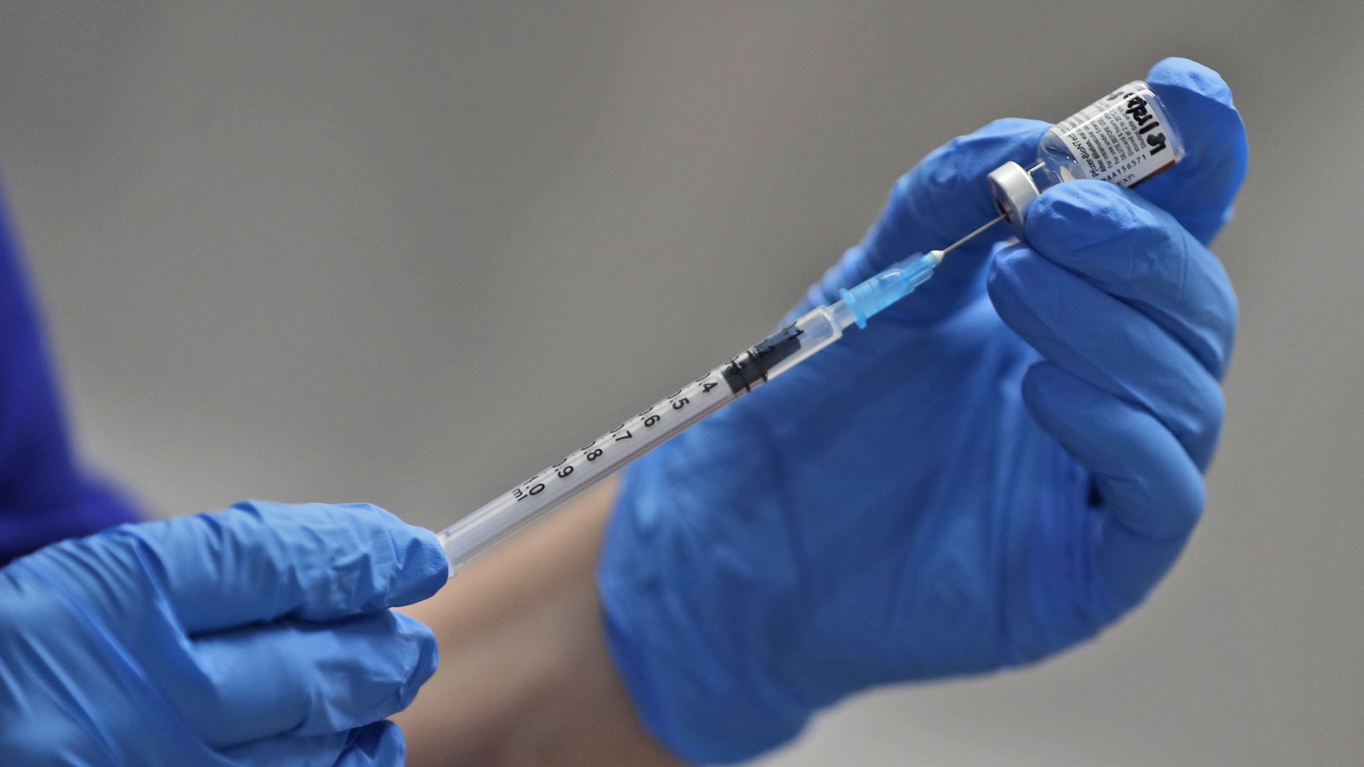 A nurse in London prepares a dose of Pfizer-BioNTech's COVID-19 vaccine on Dec. 8.