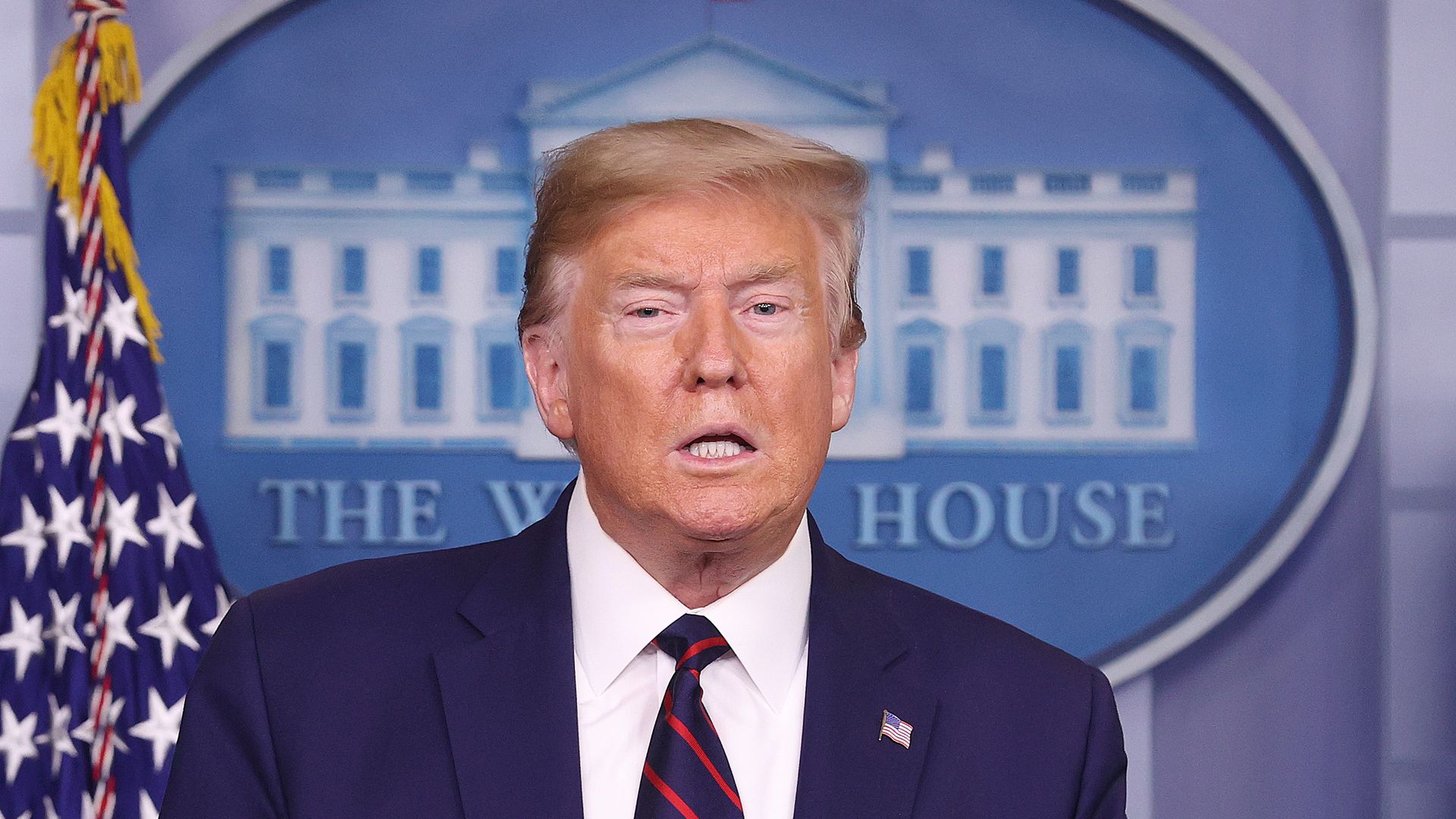 In this image, Trump stands 