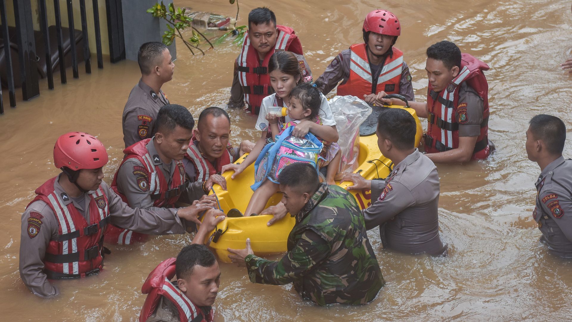 A rescue team evacuates residents from their flooded houses in Jakarta. 