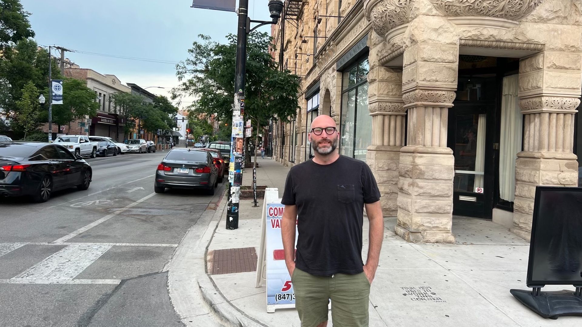 Photo of a man standing on a street corner 