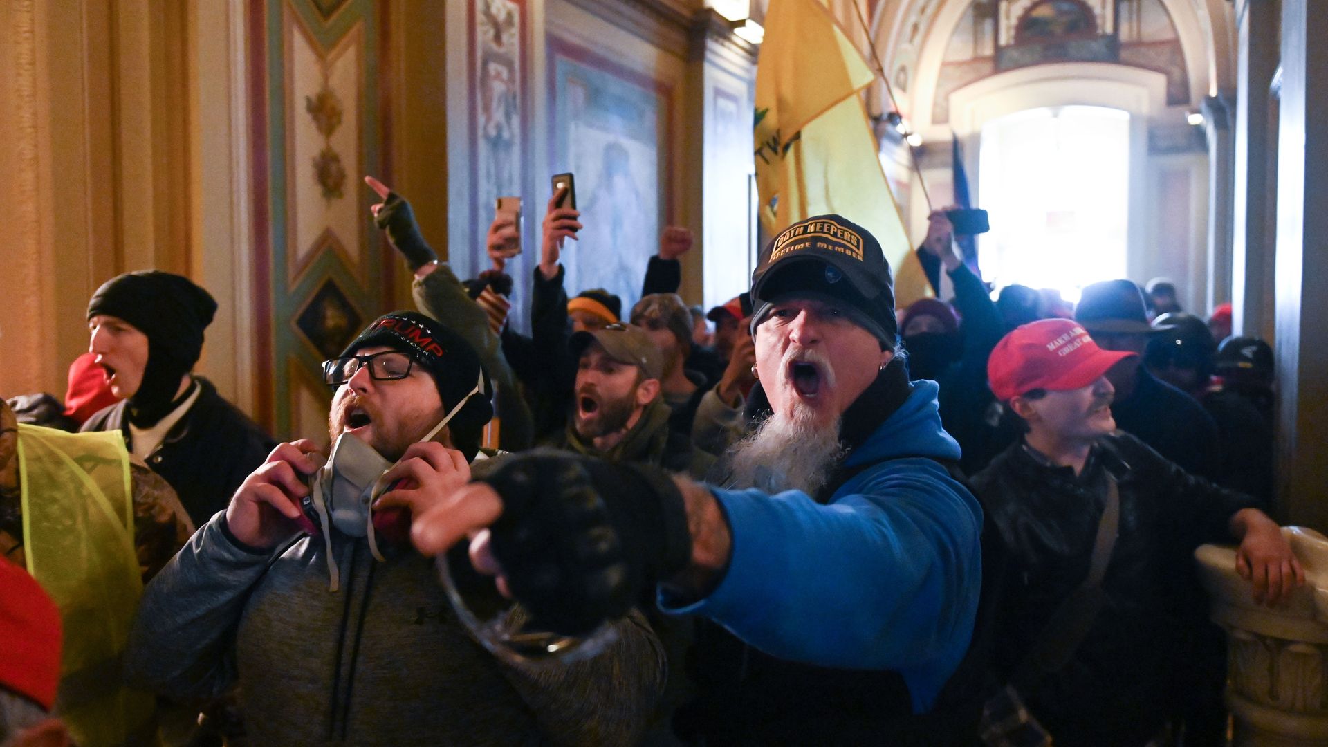 Photo of pro-Trump supporters yelling as they storm Capitol Hill