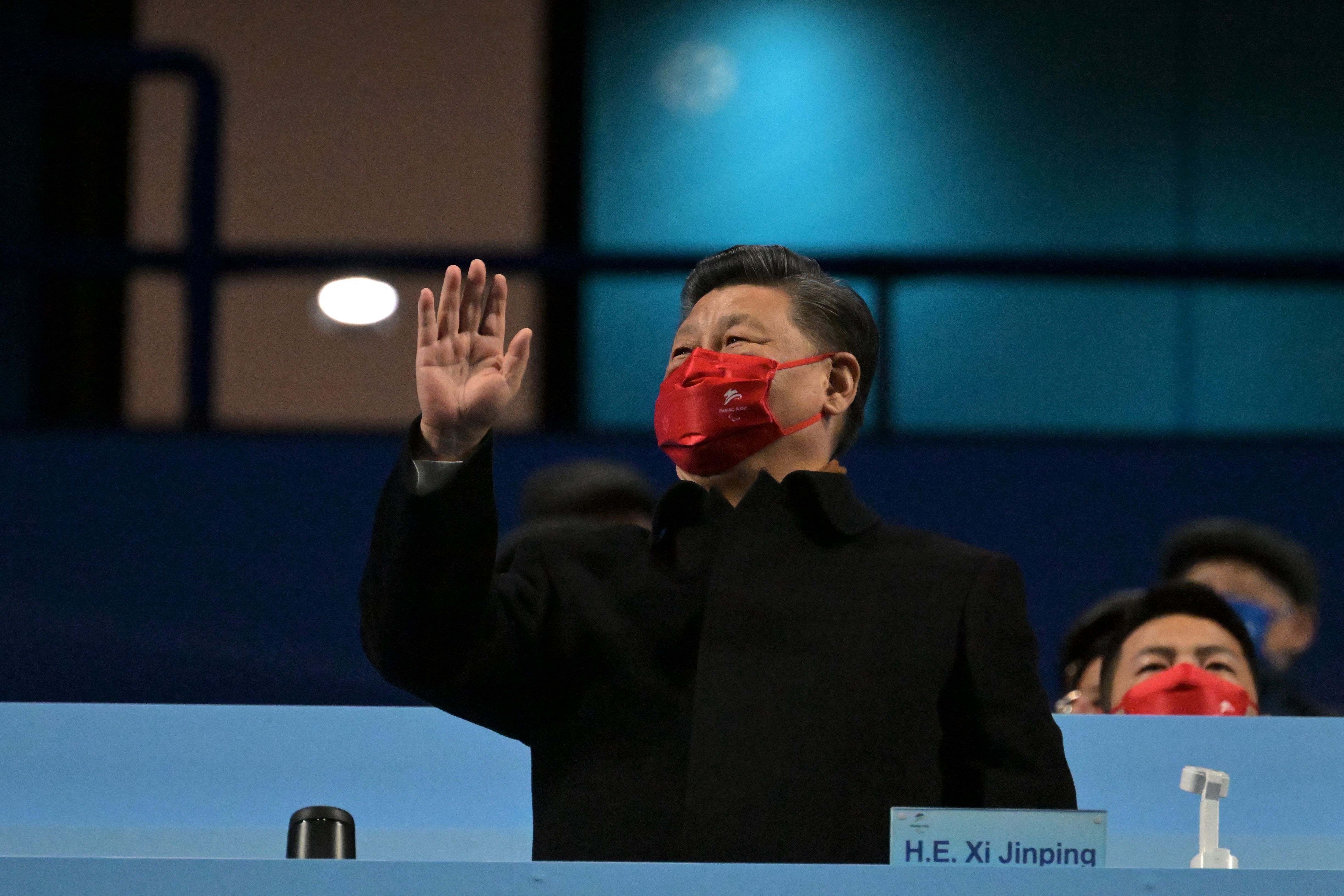 China's President Xi Jinping waves during the opening ceremony.