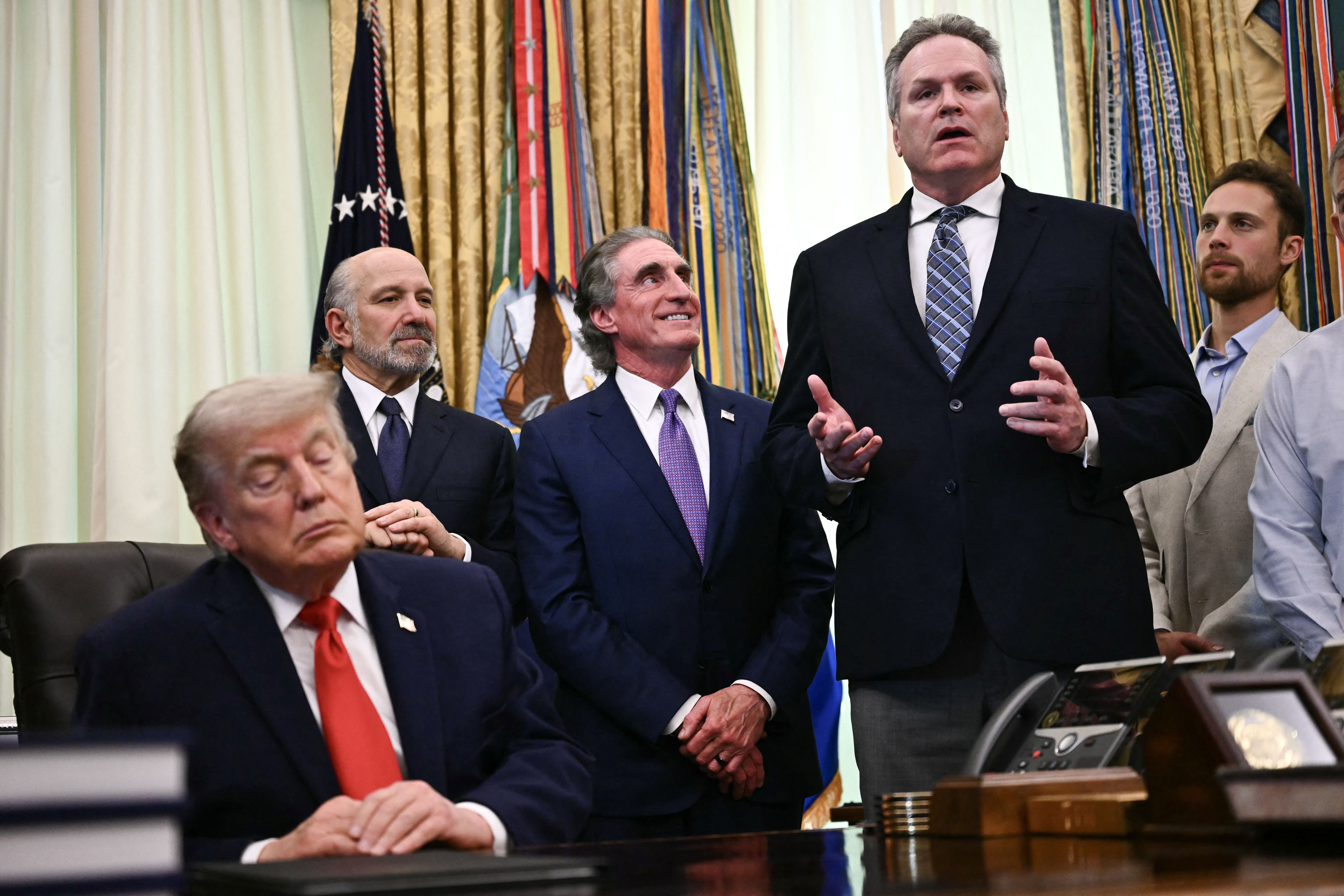 President Donald Trump, Commerce Secretary Howard Lutnick and Interior Secretary Doug Burgum listen to Alaska Gov. Mike Dunleavy before Trump signed a proclamation in the Oval Office of the White House in Washington, DC, on June 11, 2026.