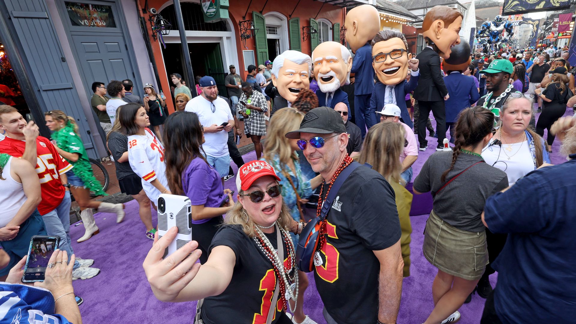 A couple of Kansas City fans snap a selfie on a crowded Bourbon Street.