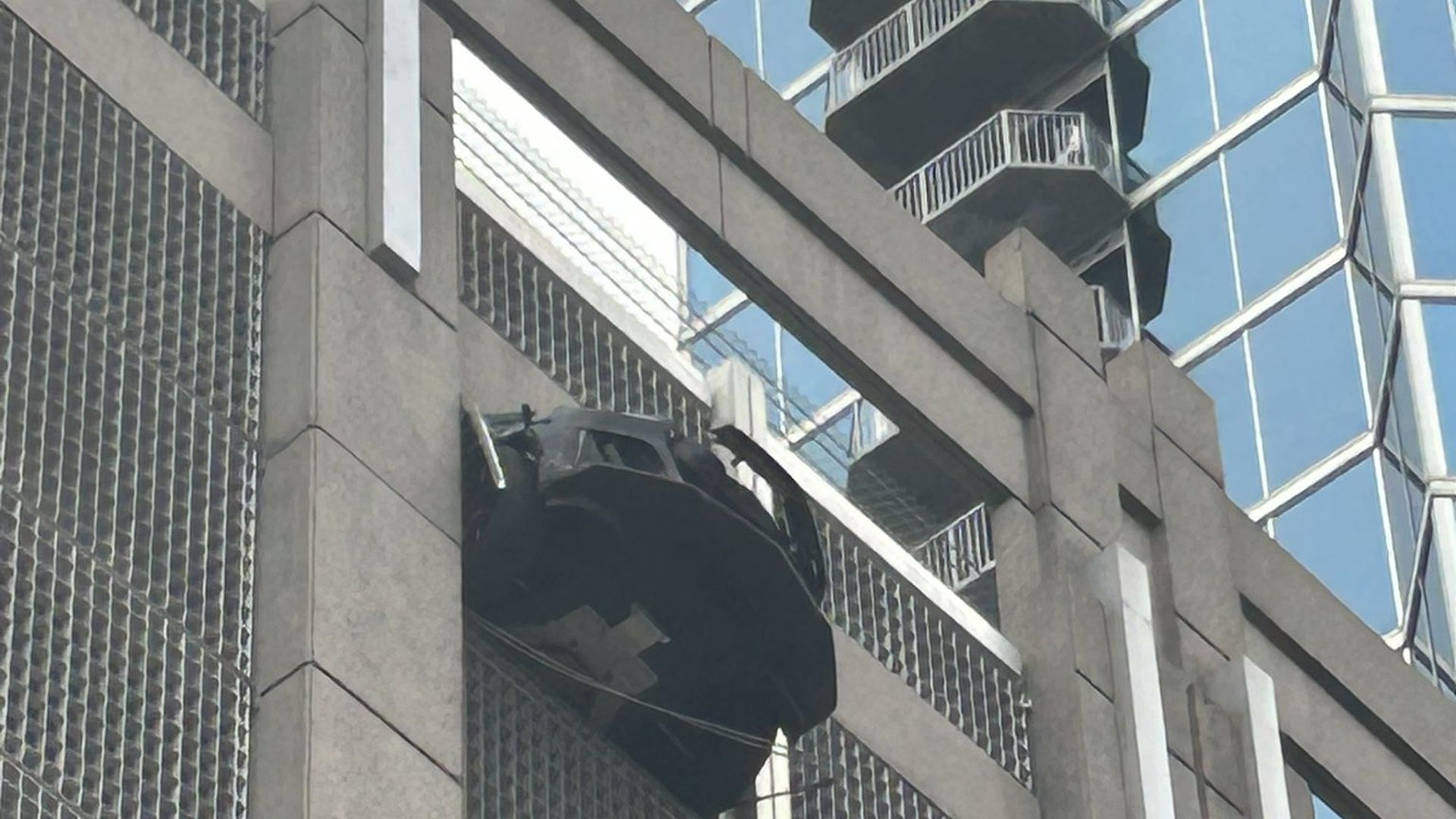 front of car hanging from parking deck