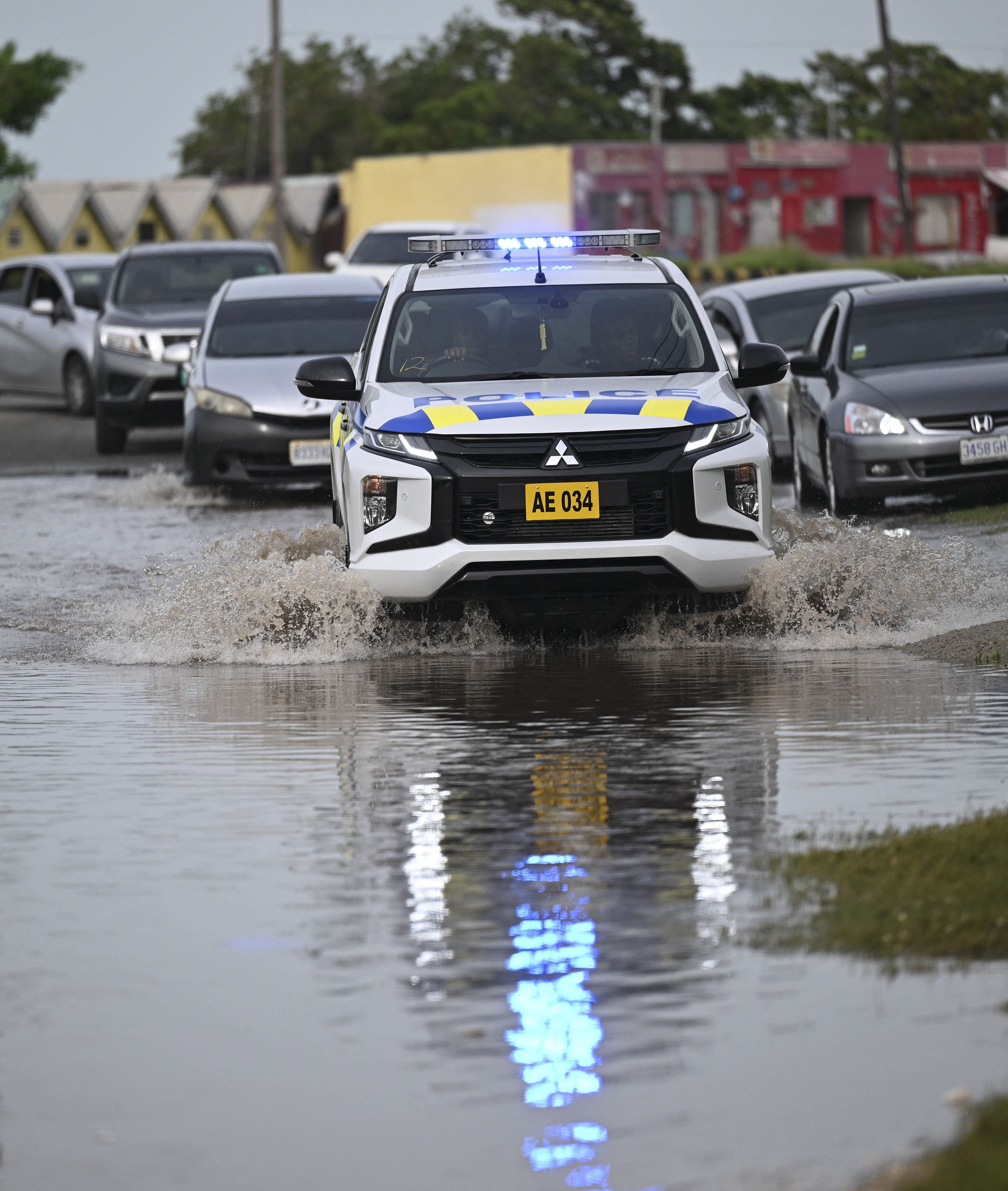 Police drive through floodwaters in Kingston, Jamaica, in the aftermath of Hurricane Beryl on July 4, 2024. Beryl powered towards Mexico and the Cayman Islands early on July 4, threatening strong winds and a storm surge after battering Jamaica's southern coast. 