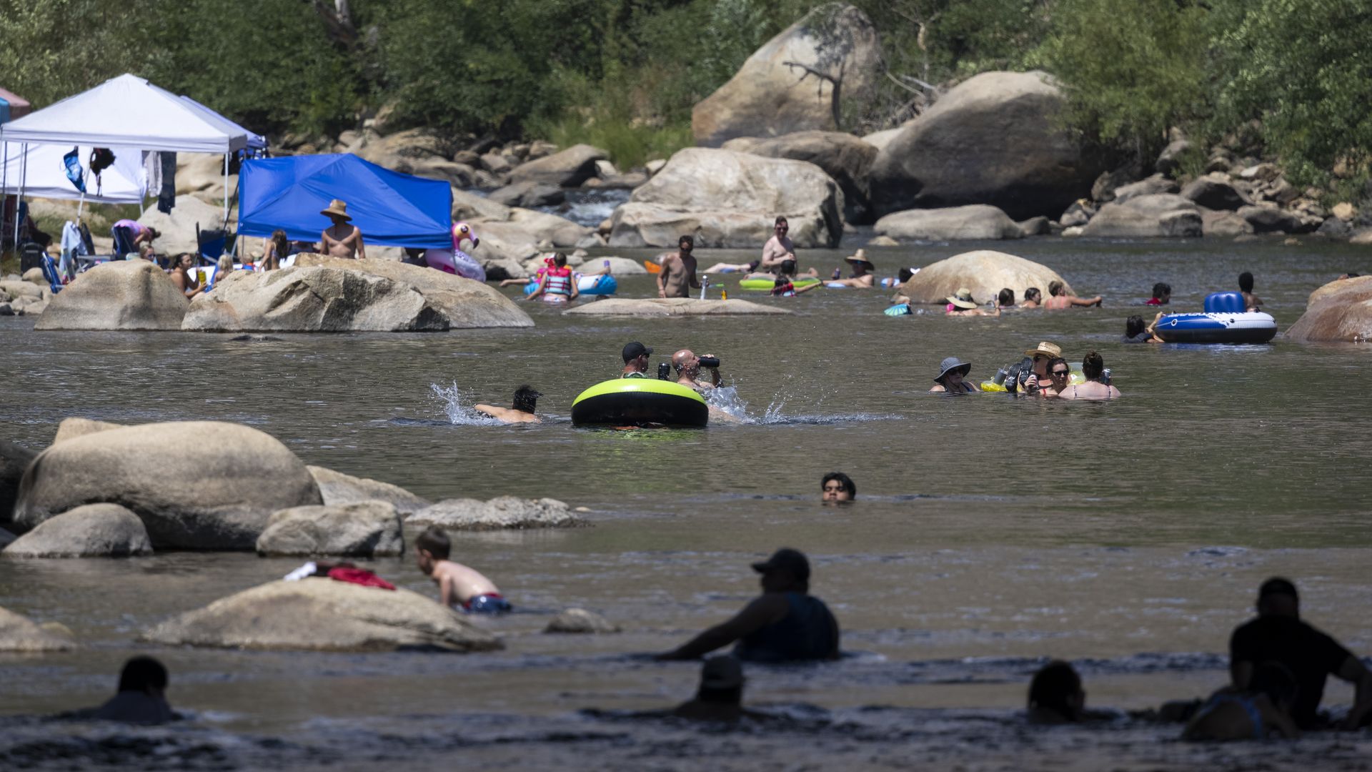 Photo of people in a swimming hole with boulders
