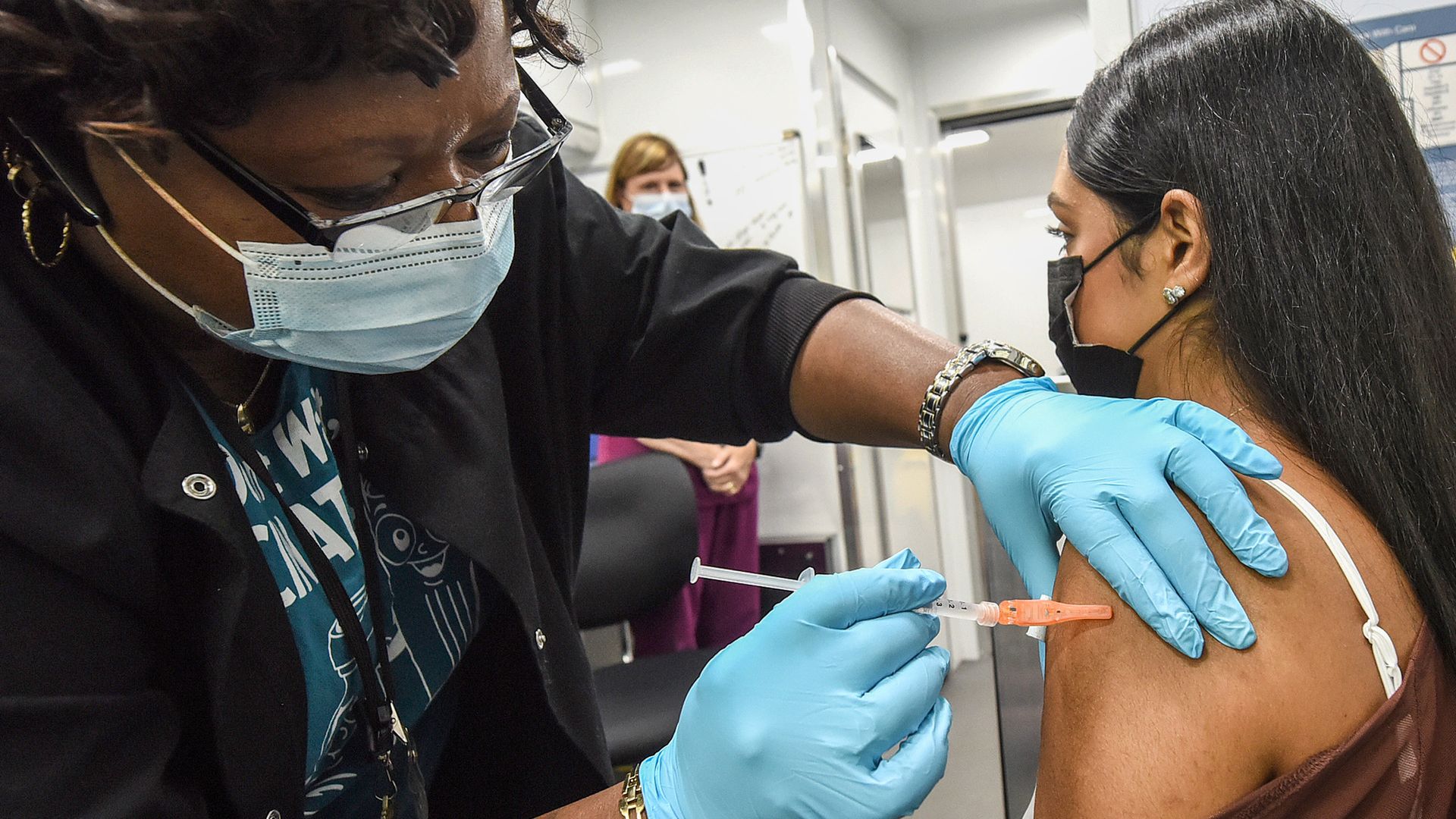 Nurse Carlene Fleming administers a dose of COVID-19 vaccine to a patient at a mobile vaccination event at the downtown Orlando campus of the University of Central Florida and Valencia College.
