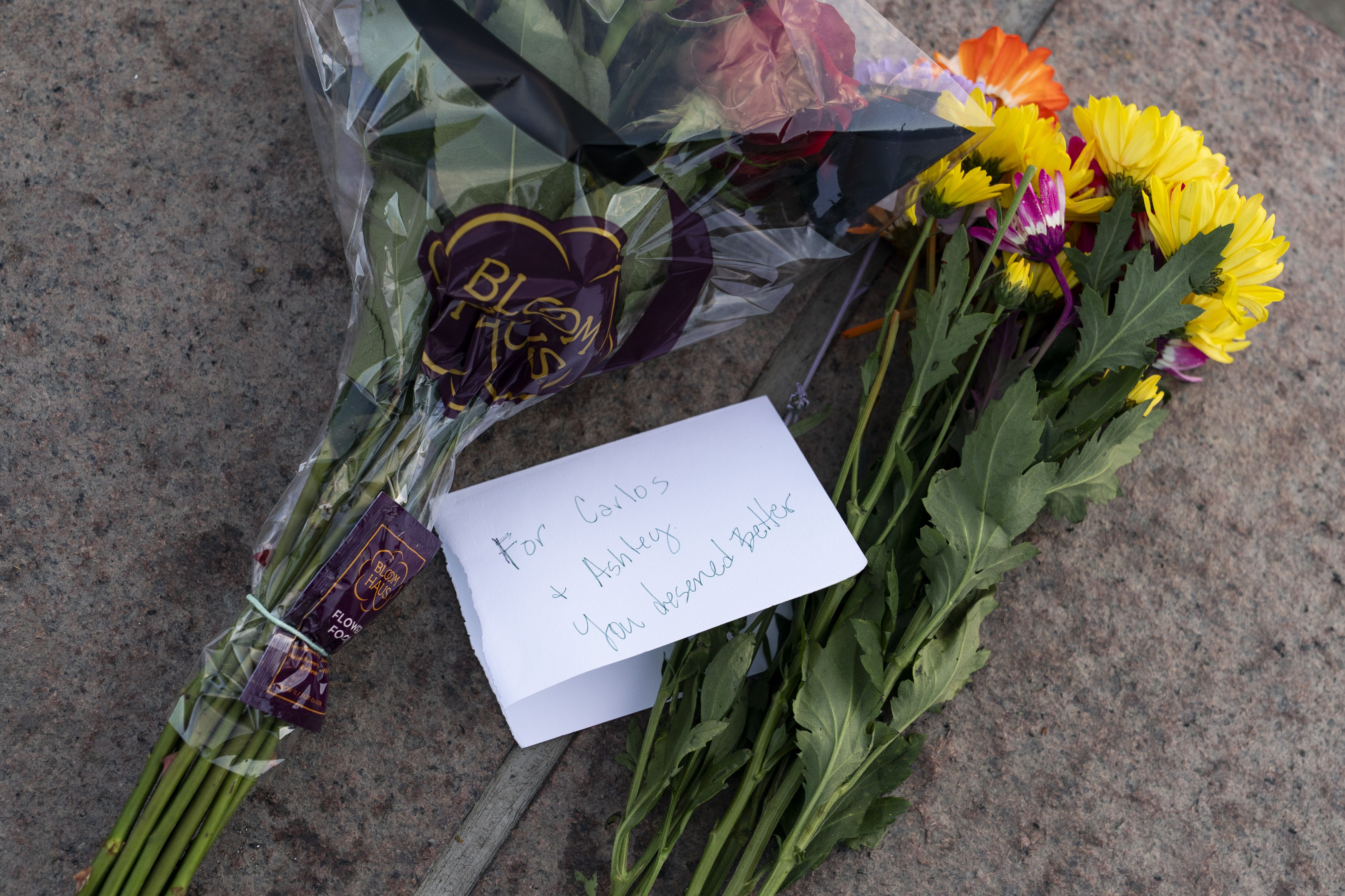Two bouquets with a card that reads "For Carlos + Ashley You deserved better."