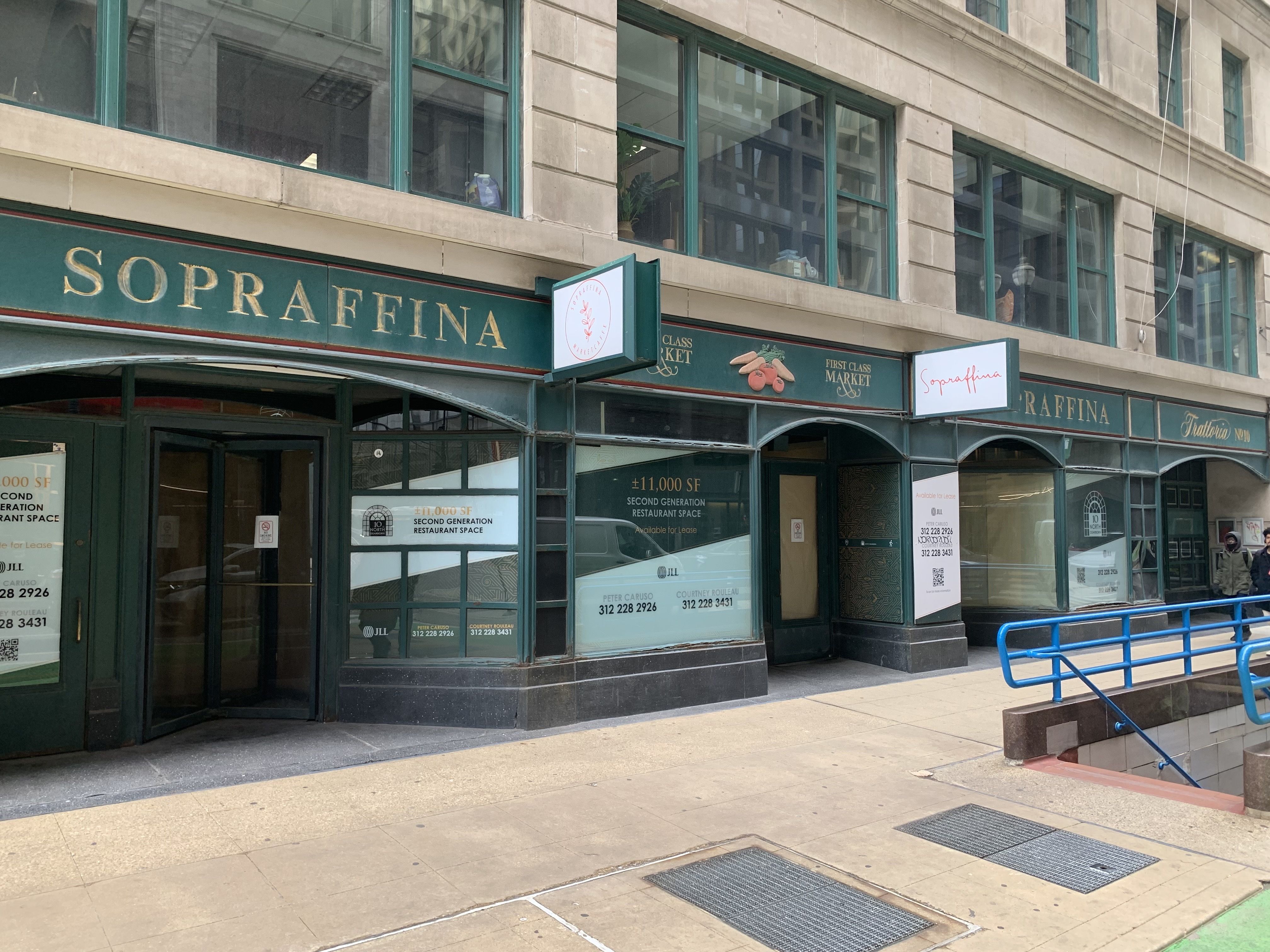 Empty storefront with green and gold signage reading "Sopraffina" and "Second Generation Restaurant Space" available for lease, in an urban building with large windows.