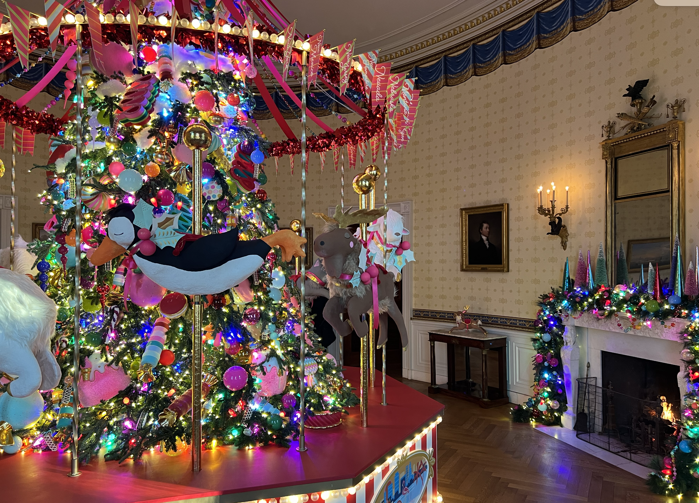 The Blue Room showcases the official White House Christmas Tree with a colorful carousel moving around it. 