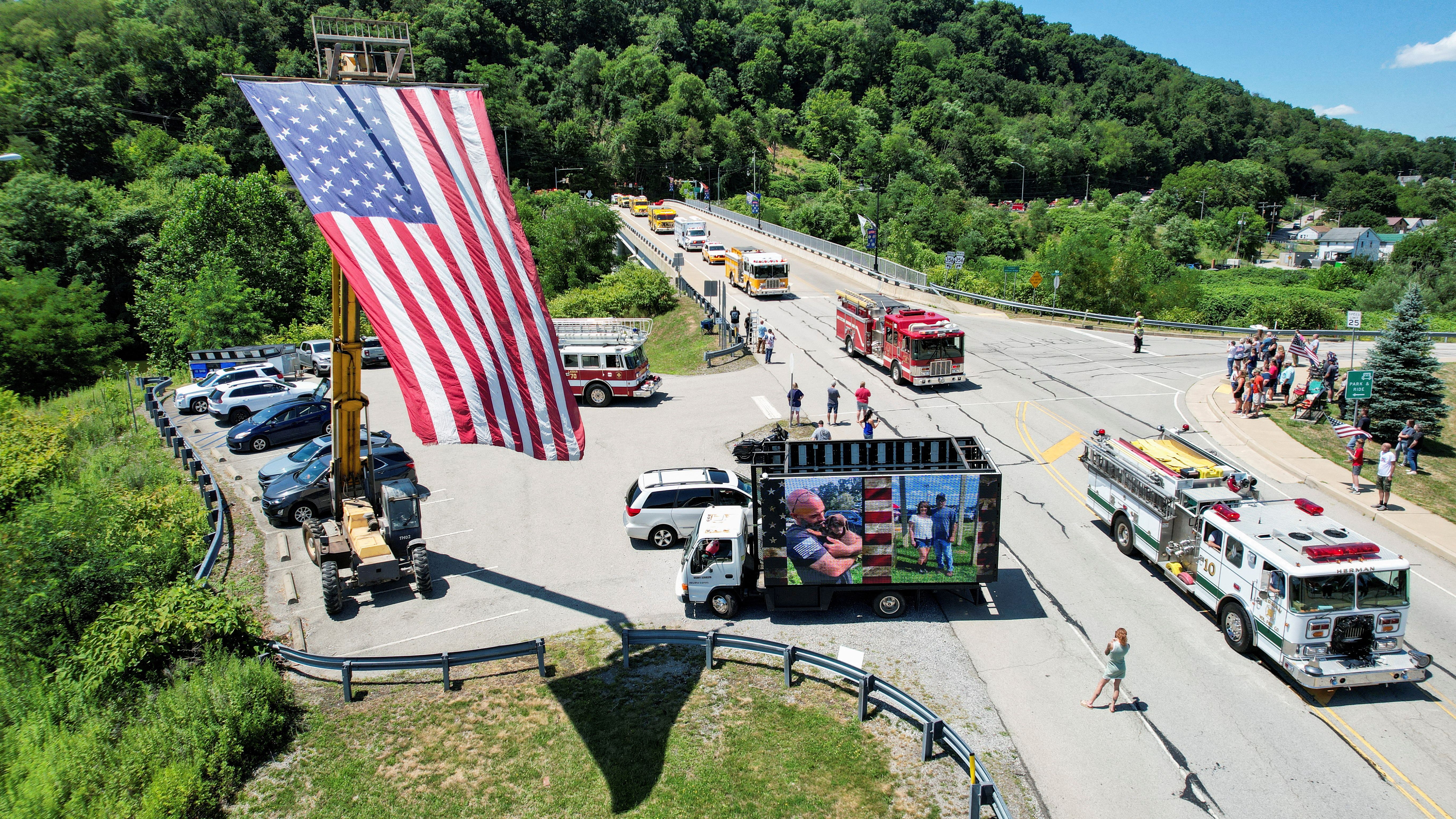 A bird's eye view of fire trucks and an American flag
