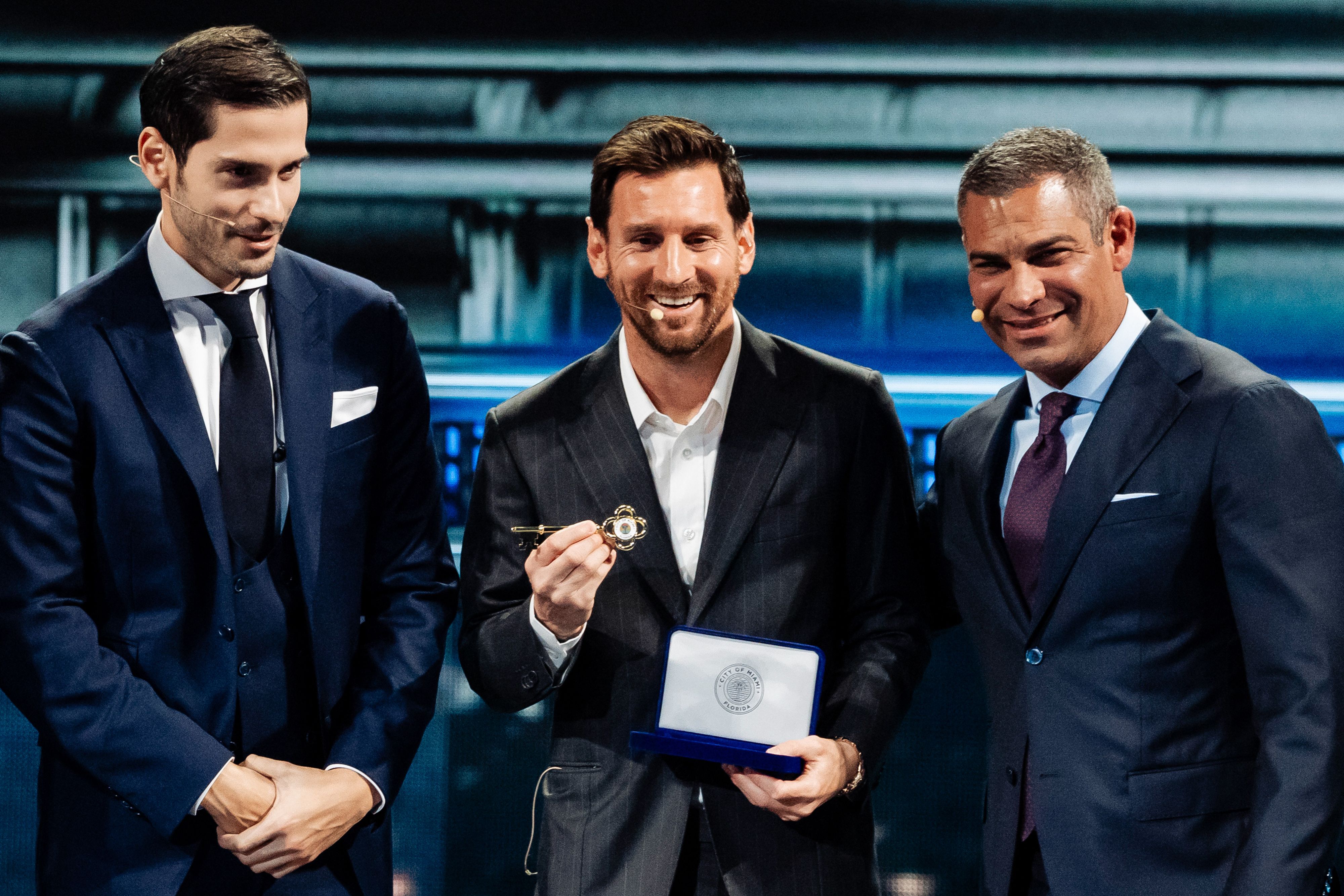 Lionel Messi, a soccer player for the Inter Miami, center, flanked by Ignacio Gonzalez Castro, founder and chief executive officer of the American Business Forum, left, and Francis Suarez, mayor of Miami, right, holds the key to the city of Miami during the America Business Forum in Miami, Florida, 