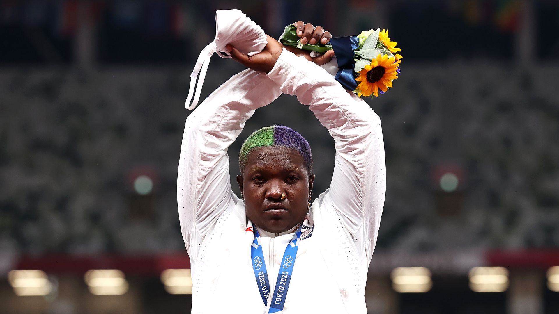 Raven Saunders of Team United States makes an 'X' gesture during the medal ceremony for the Women's Shot Put on day nine of the Tokyo 2020 Olympic Games