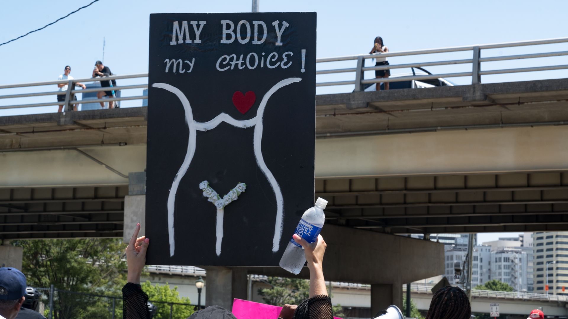 holding sign: my body, my choice