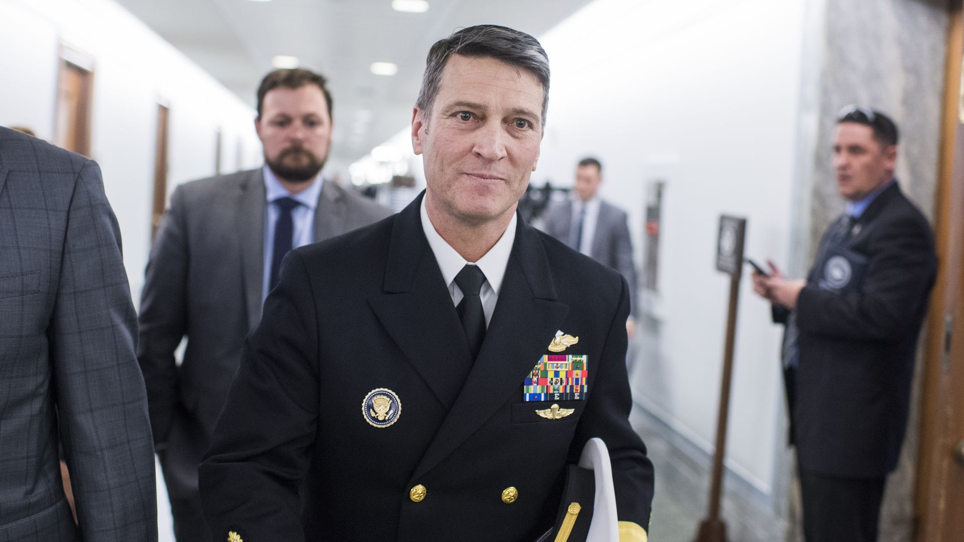 Ronny Jackson walking through a hallway on Capitol Hill
