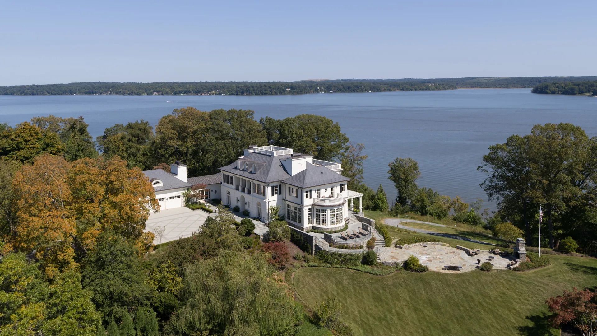A photo showing an aerial view of a large white estate sitting on the banks of the Potomac River.