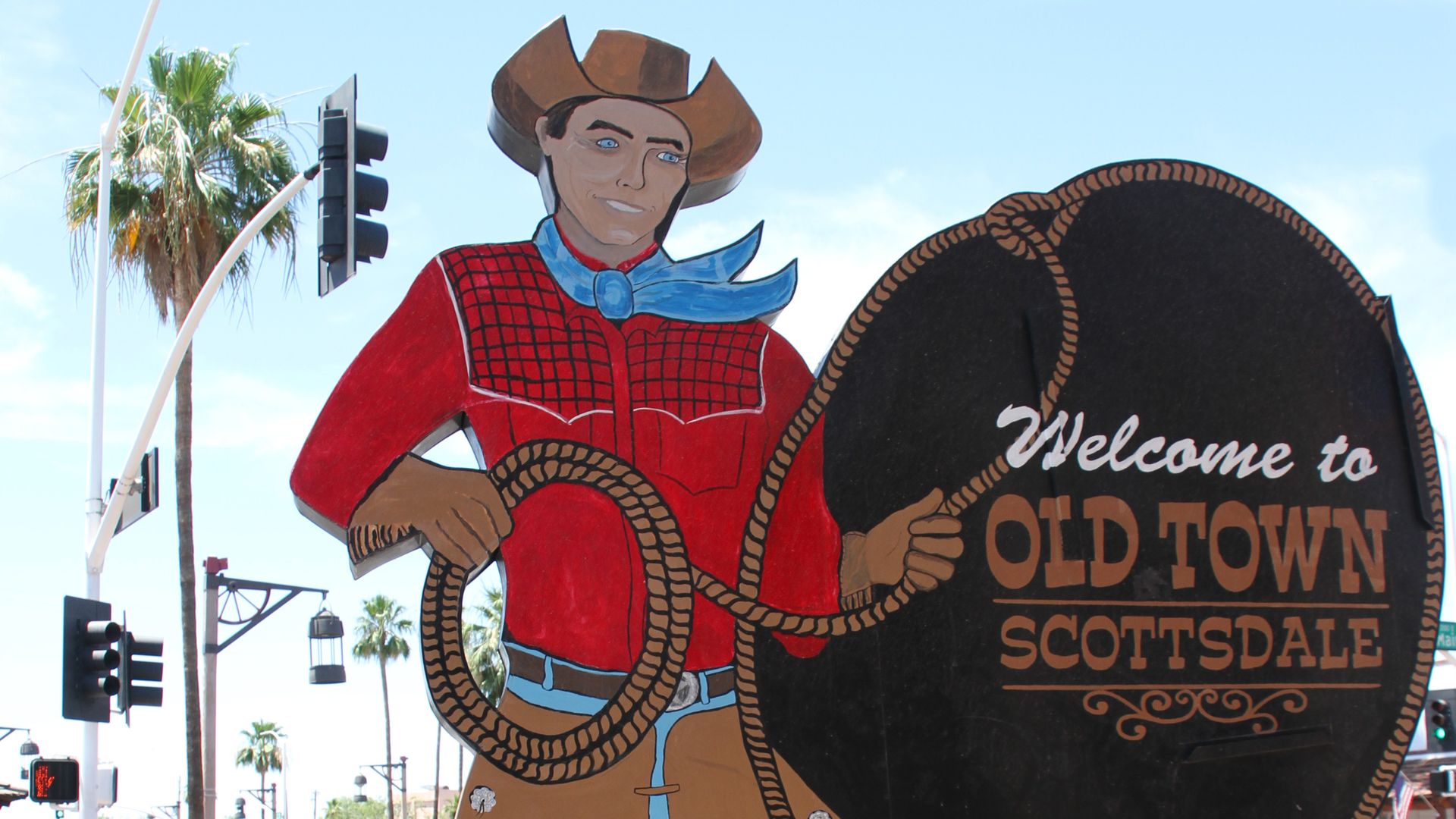 A large cowboy cutout with a sign that reads "Welcome to Old Town Scottsdale."