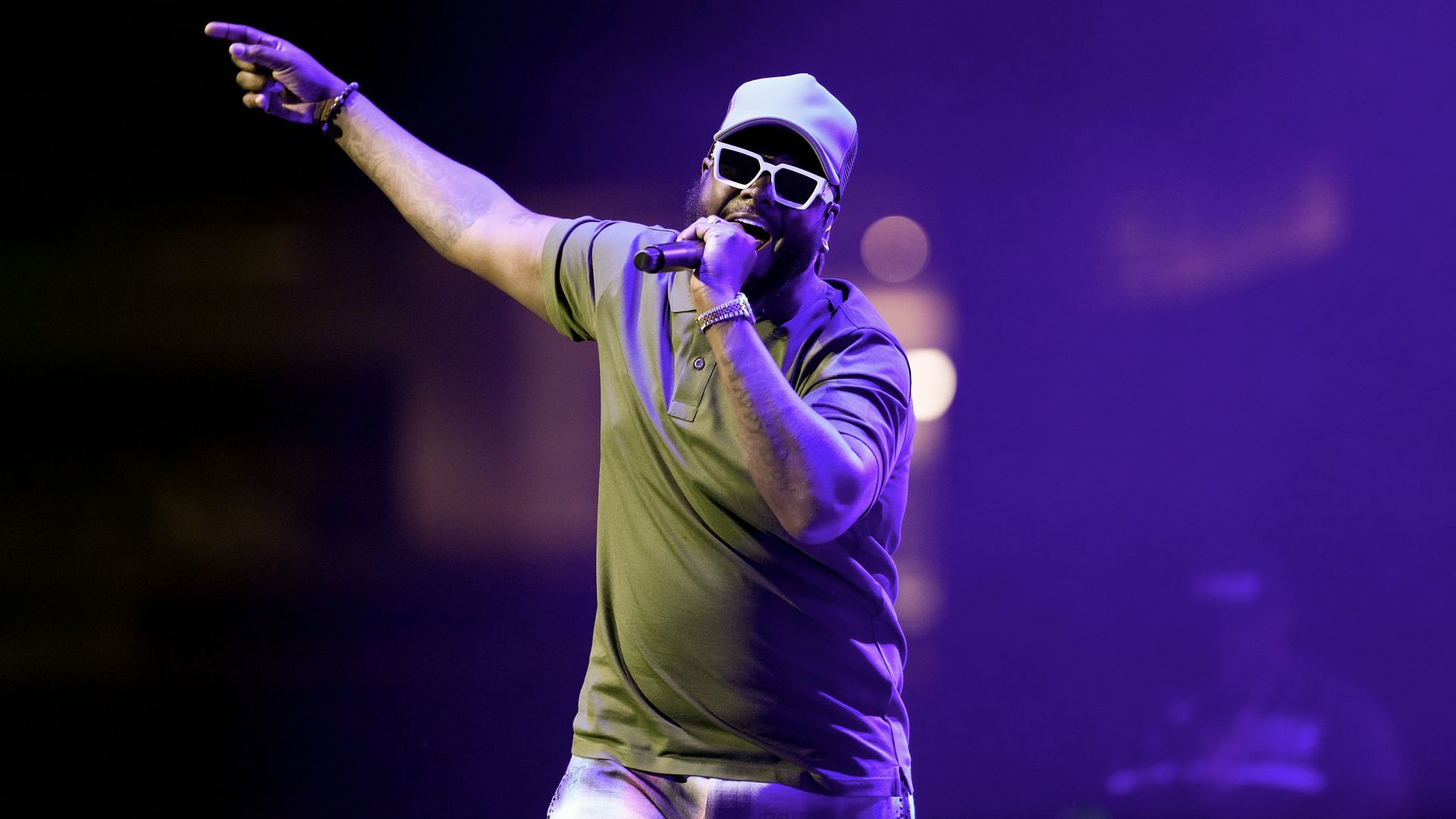 T Pain sings into a microphone.