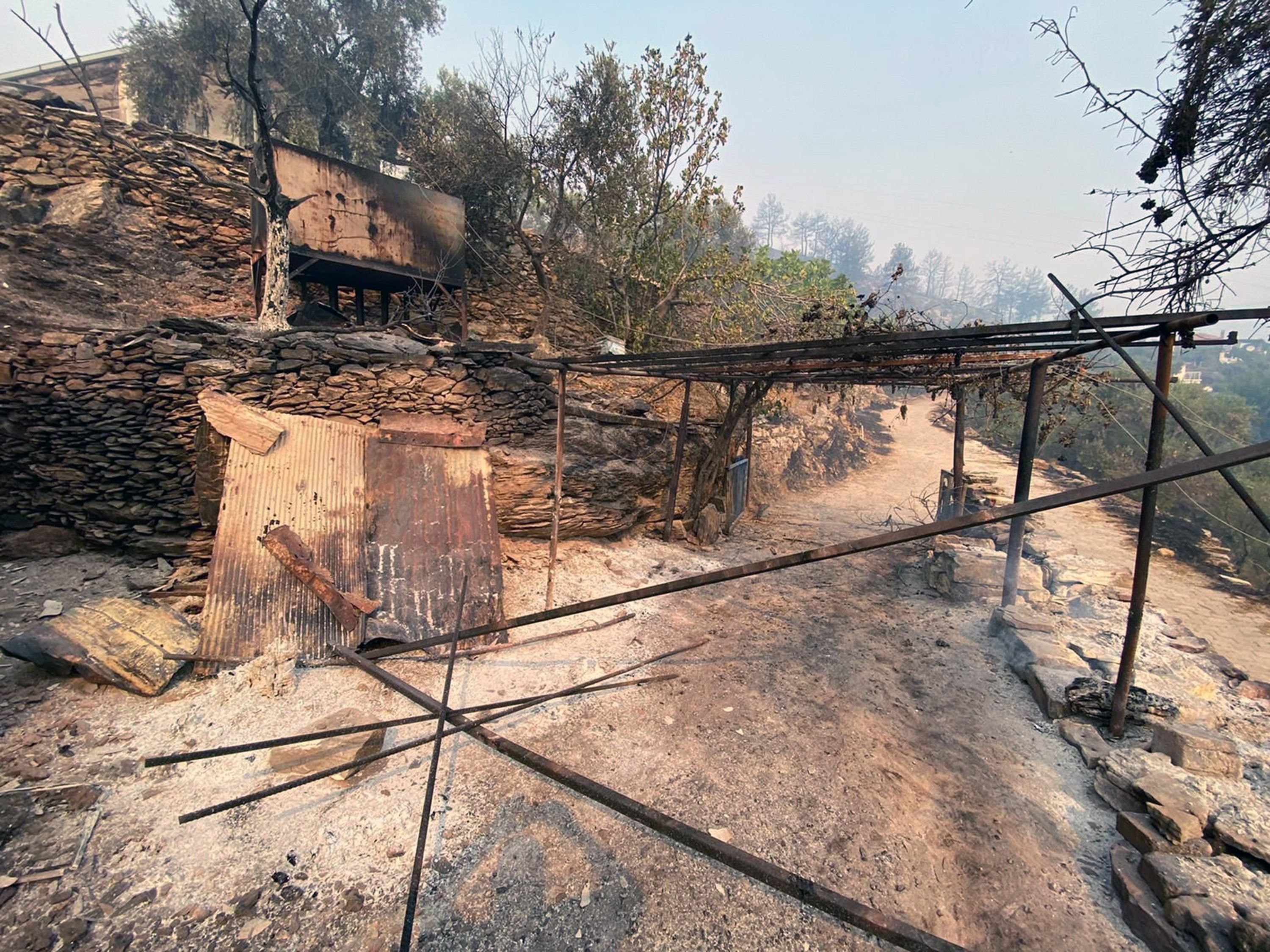 burned road and facilities after a wildfire raged in Milas, Mugla province, Turkey.