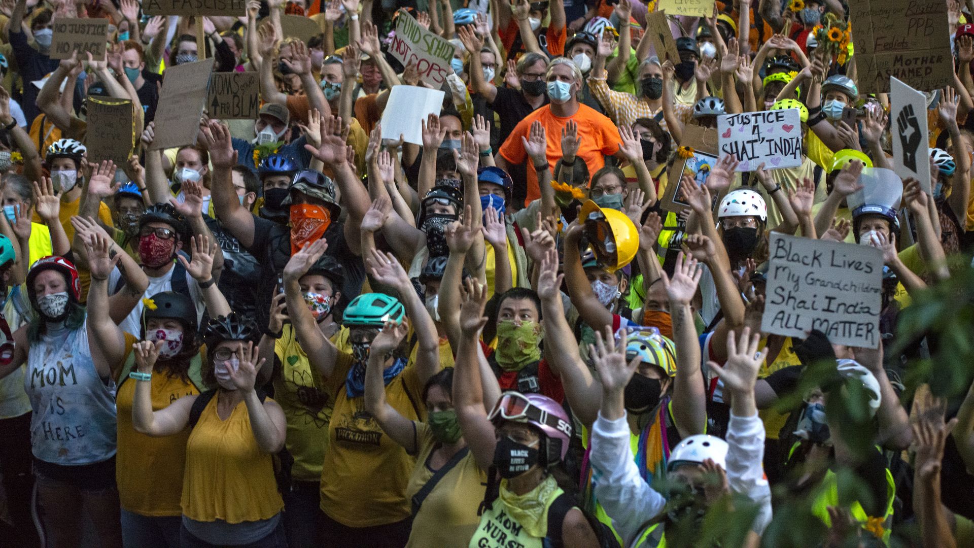 A large crowd of people wearing helmets and facemasks