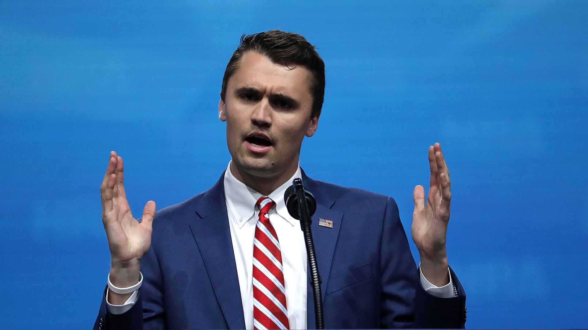 Charlie Kirk speaking behind an NRA-ILA podium