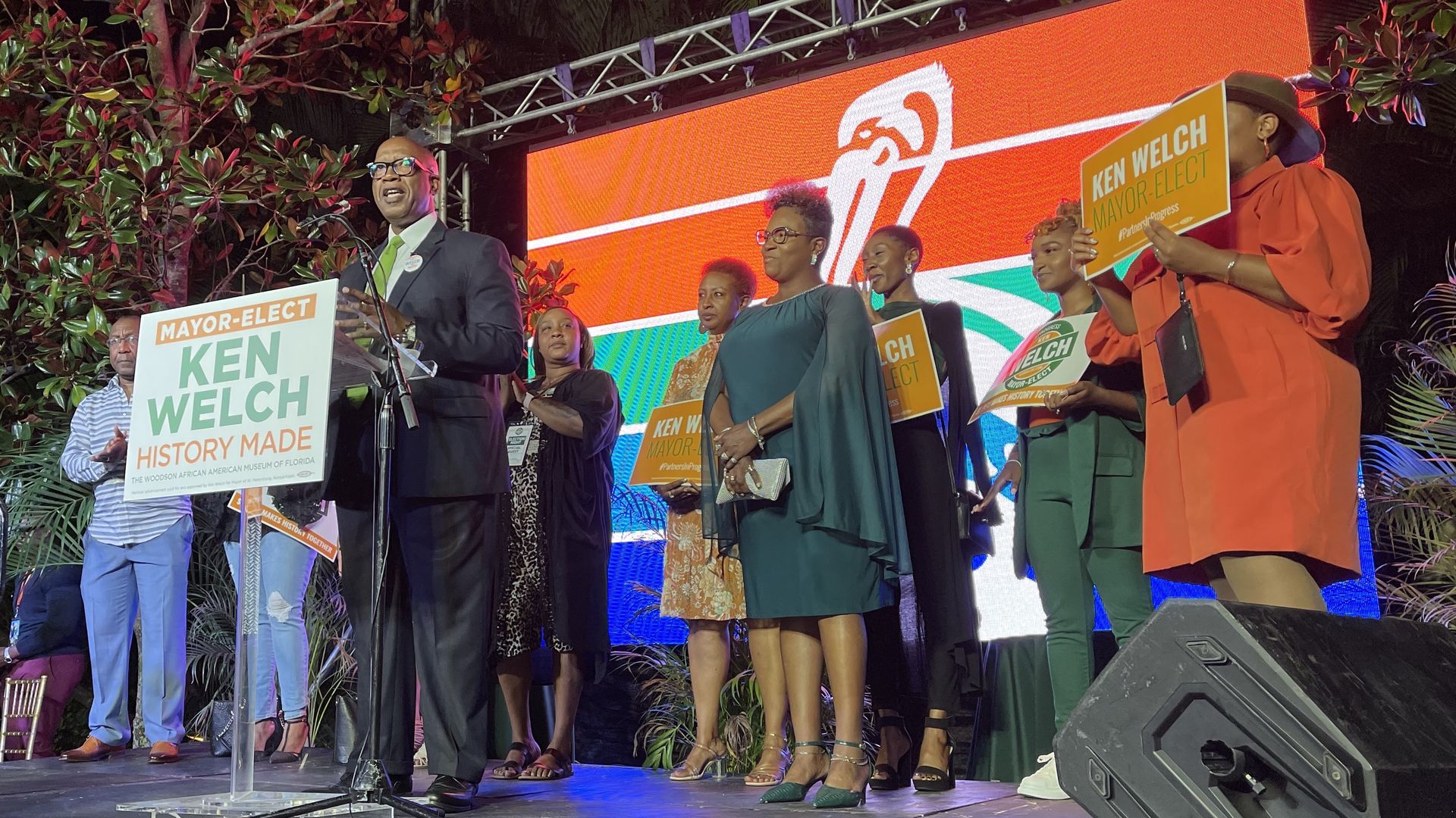 Ken welch gives his acceptance speech surrounded by family with the St. Pete logo on a screen behind him