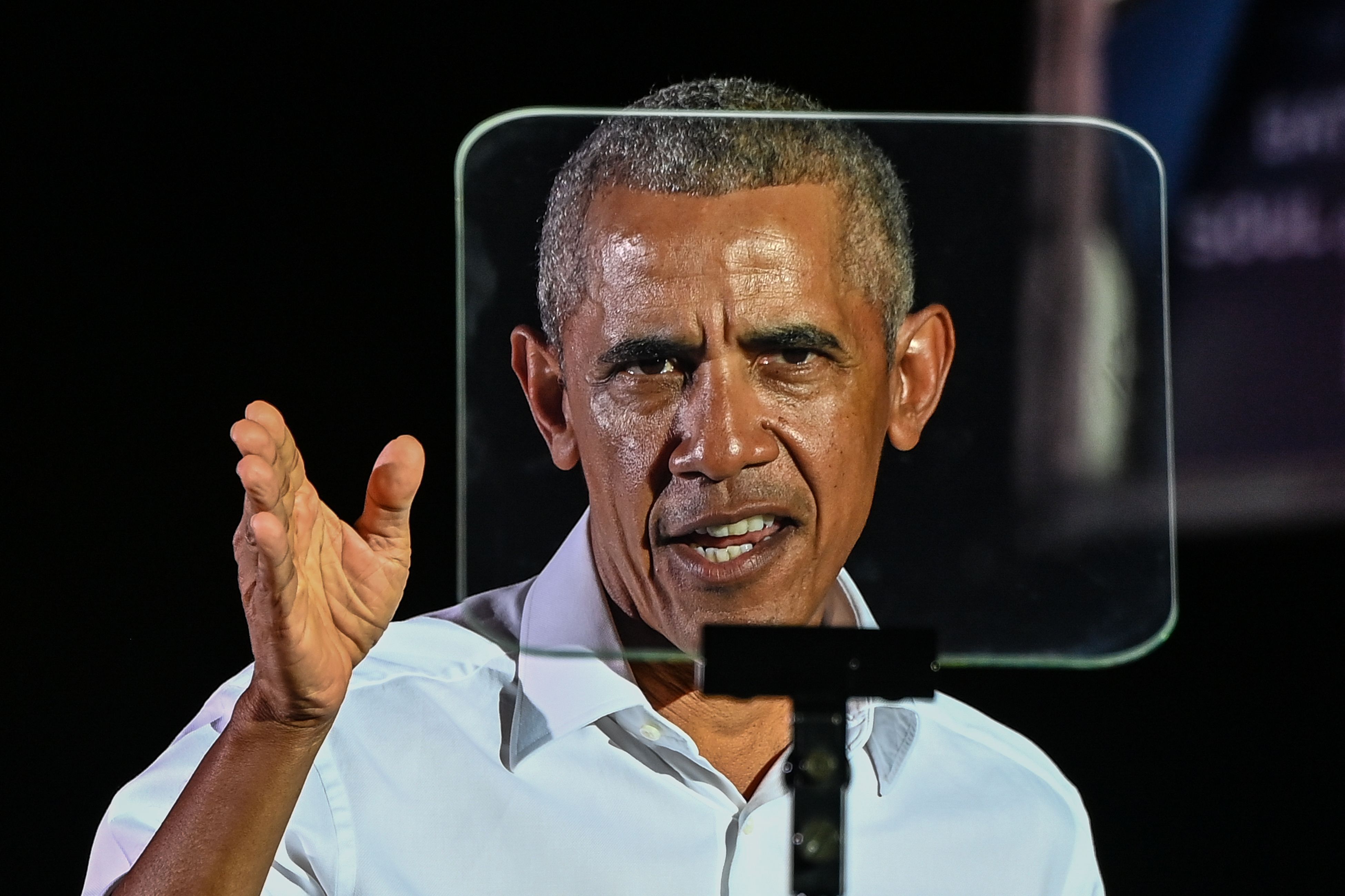 Former US President Barack Obama speaks at a drive-in rally as he campaigns for Democratic presidential candidate former Vice President Joe Biden in Miami, Florida on November 2