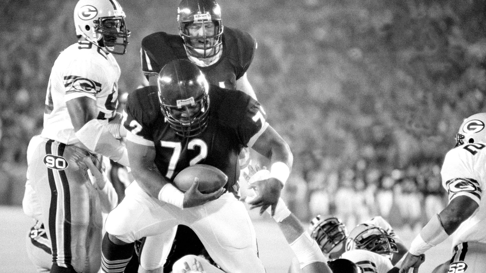 Black and white picture of football players. 