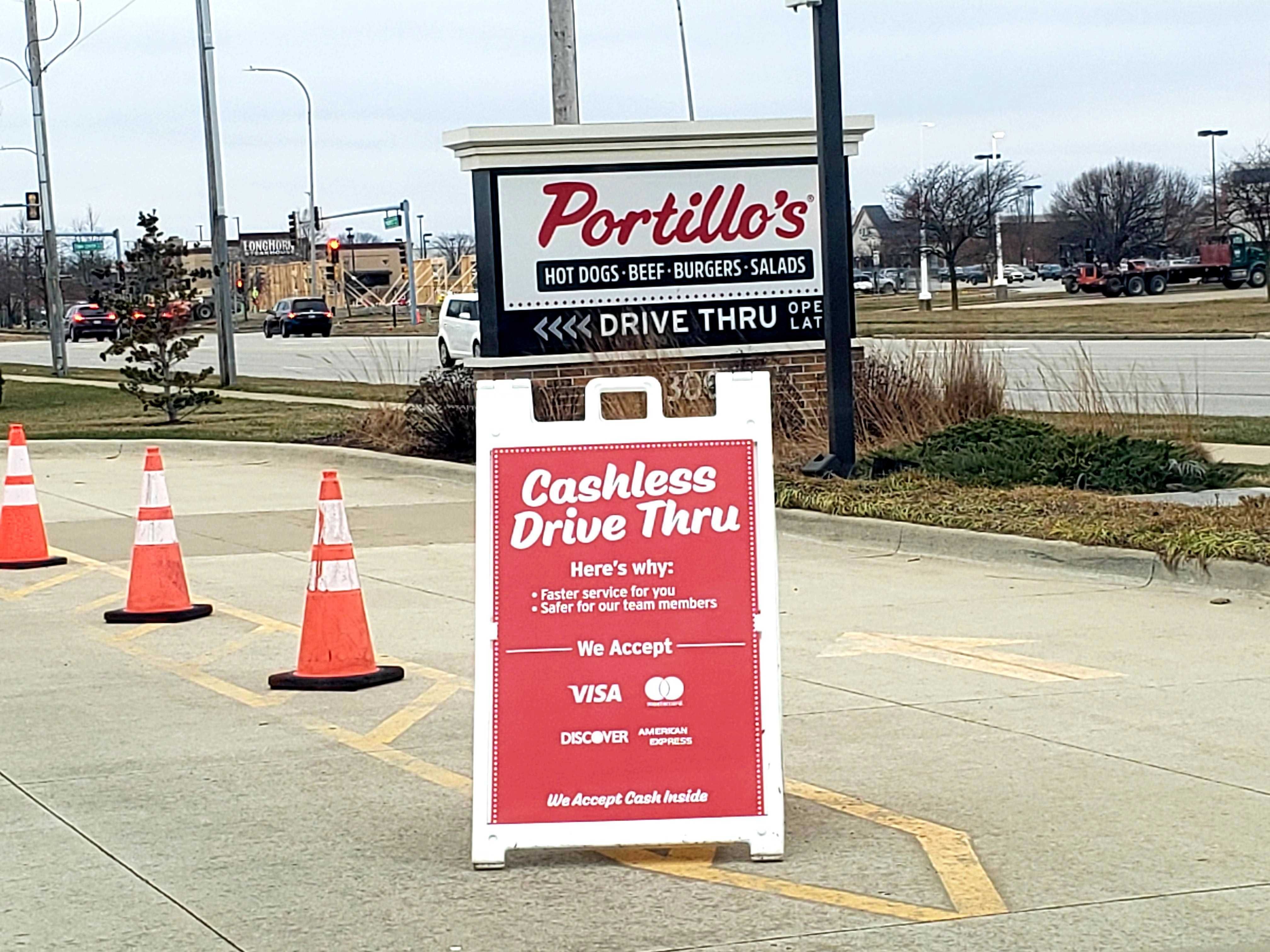 Photo of a sign that says cashless drive thru 
