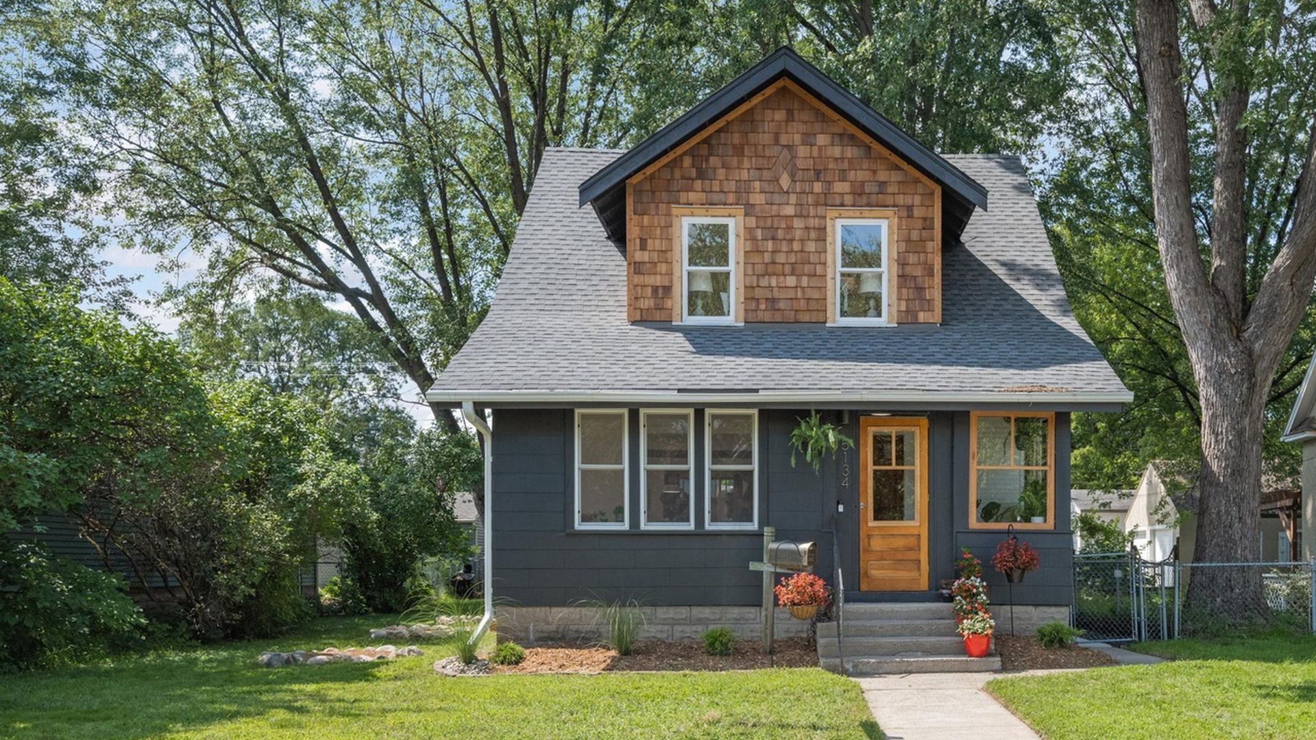 navy home exterior with wood paneling