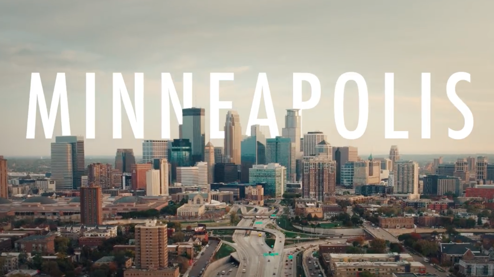 A screenshot of a video of Minneapolis, with the skyline and the city's name in text.