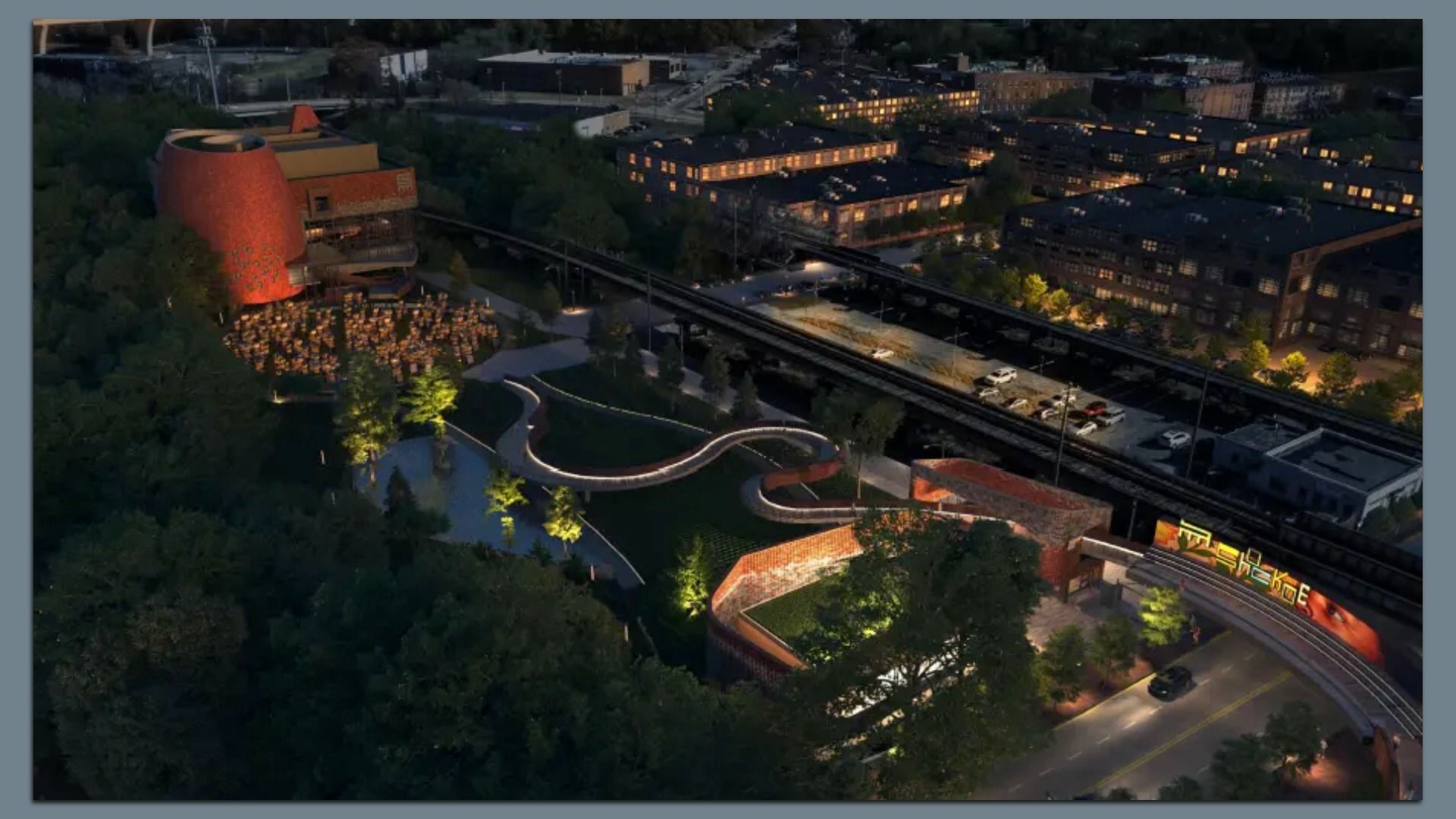 A nighttime aerial view of a rendering of a modern park with winding illuminated pathways, a red brick building, and nearby residential buildings with lit windows.