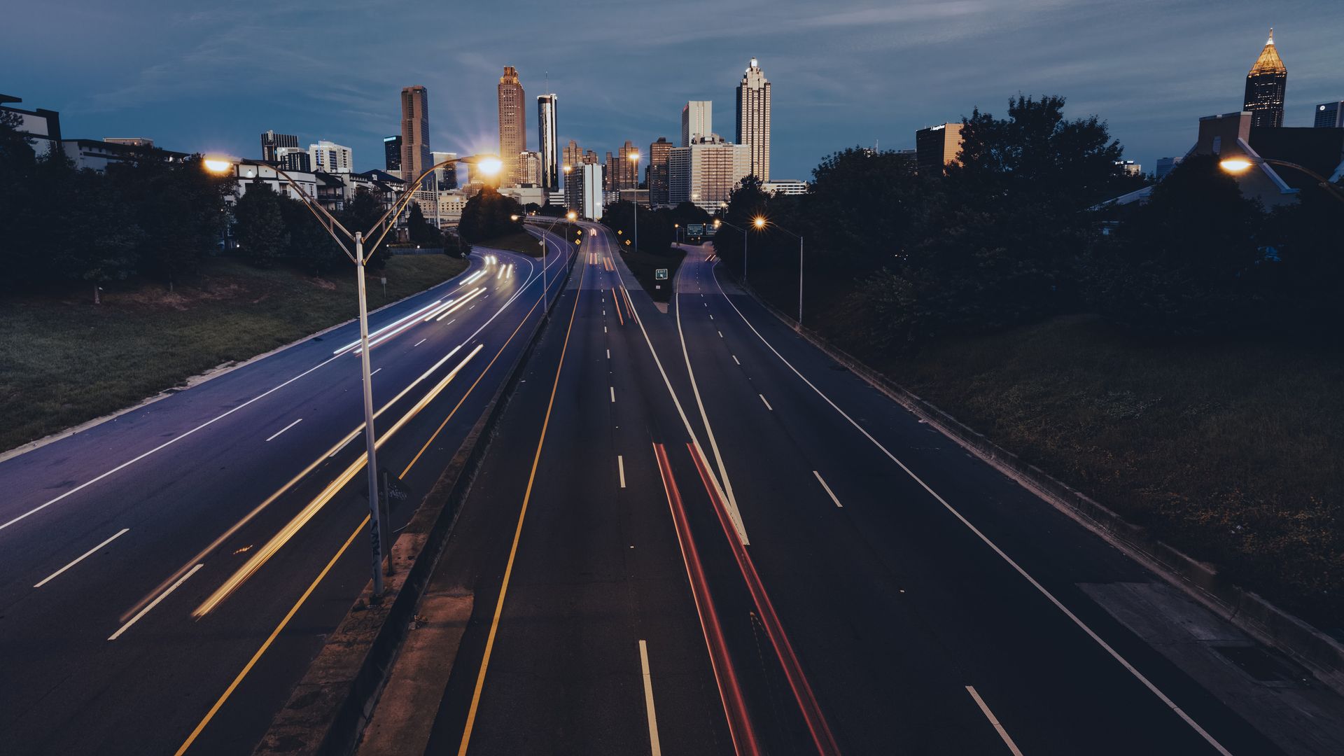 highways lead to the Atlanta skyline at night