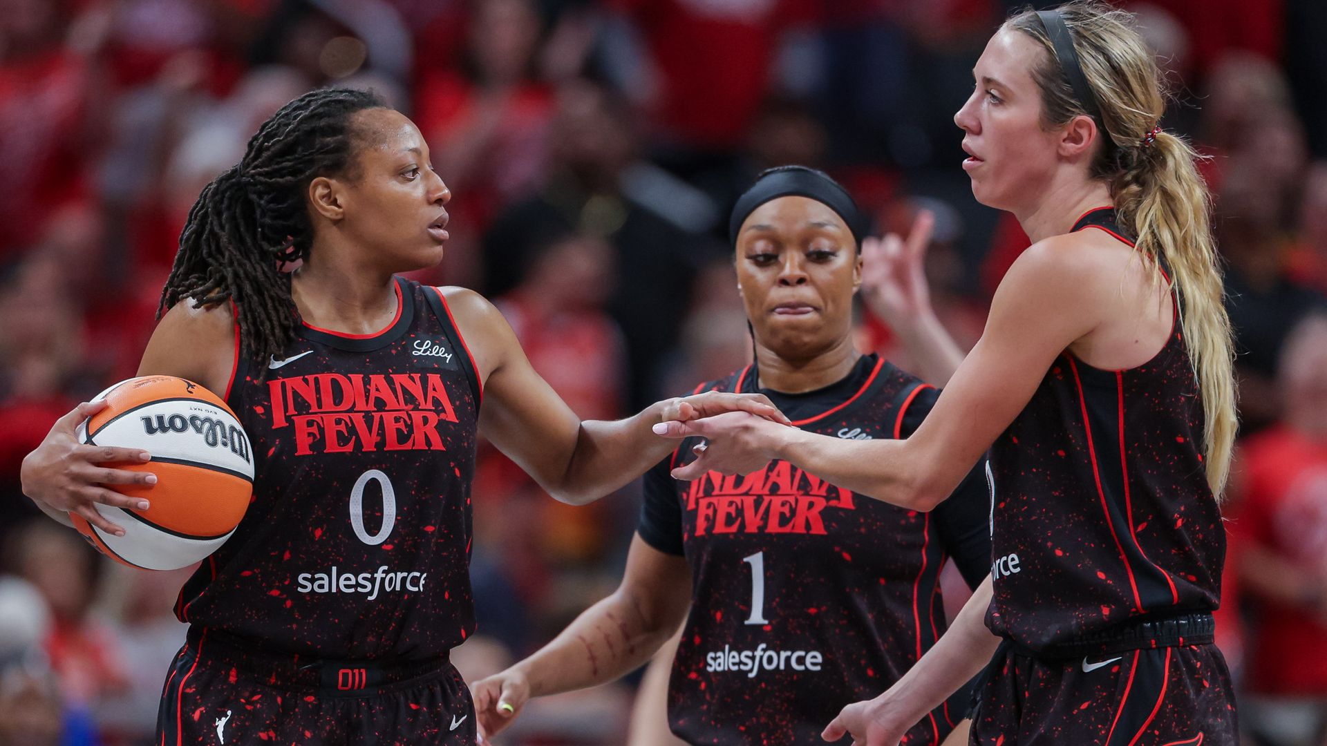 Kelsey Mitchell #0 and Lexie Hull #10 of the Indiana Fever celebrate during the second half against the Las Vegas Aces in Game Four of the semifinals of the 2025 WNBA Playoffs at Gainbridge Fieldhouse on September 28, 2025 in Indianapolis, Indiana. 
