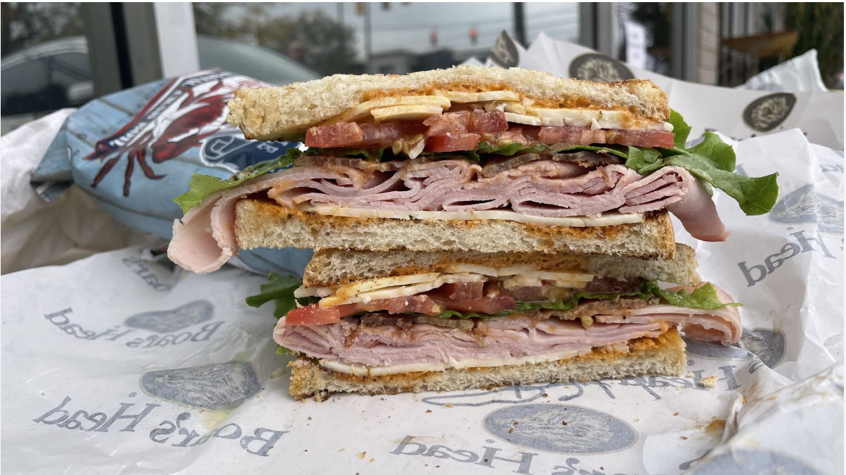 A sandwich with a lot of ham on it. 