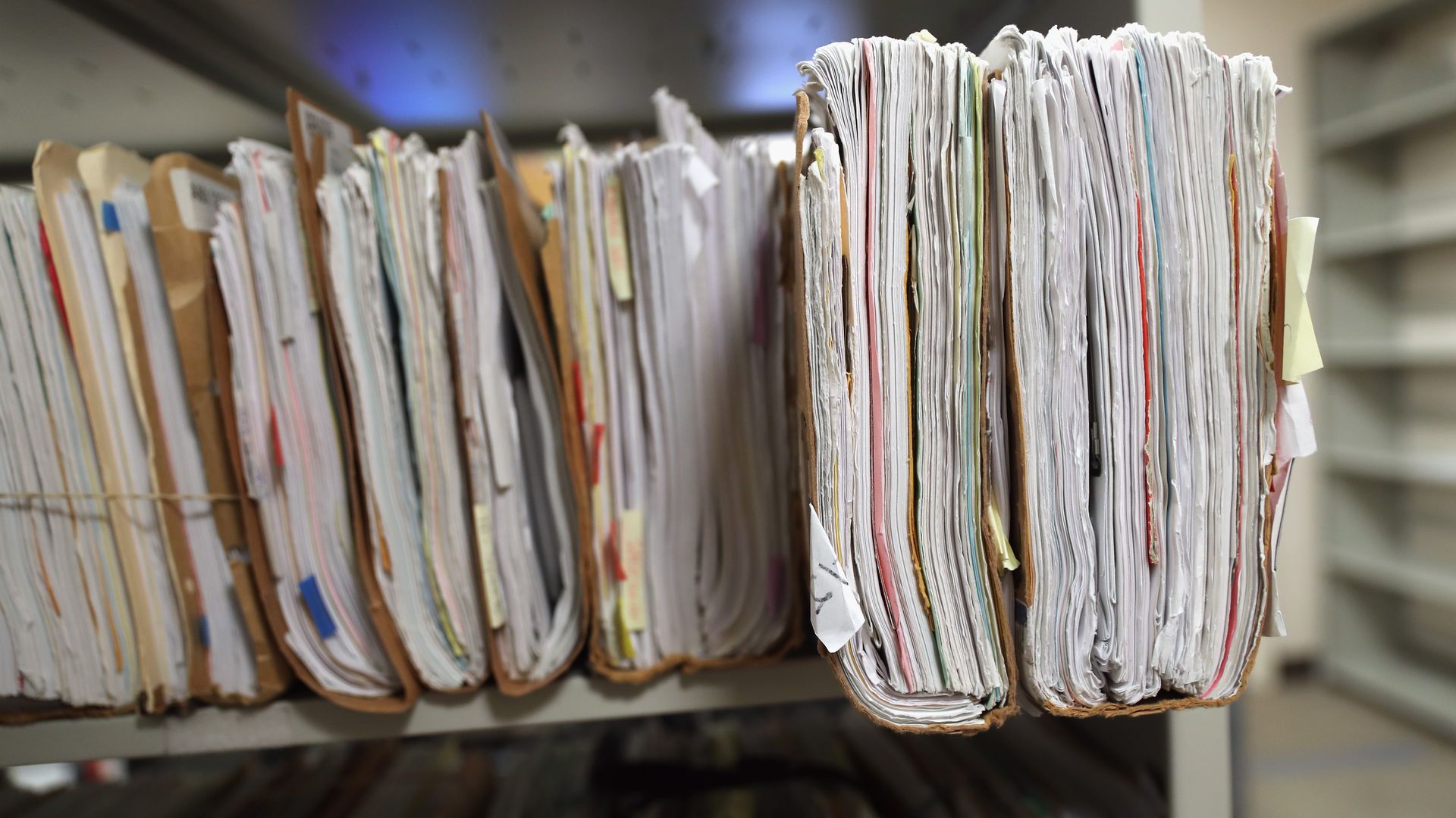 Folders with immigrants' applications for permanent U.S. residency sit stacked in a  U.S. Citizenship and Immigration Services office.